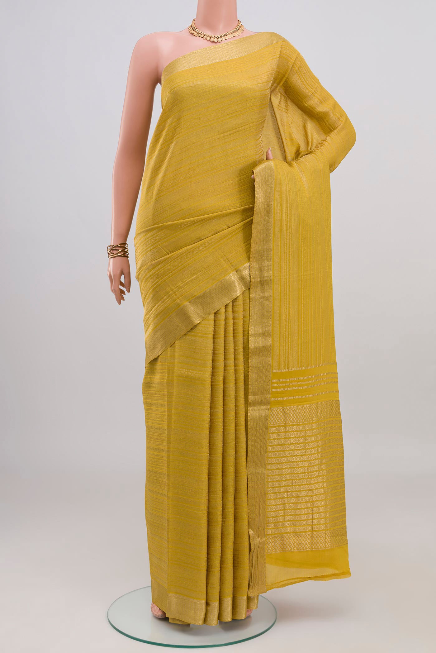 Yellow Mysore Crepe Saree with Zari Brocade on the body and Zari Border.  displayed on a mannequin