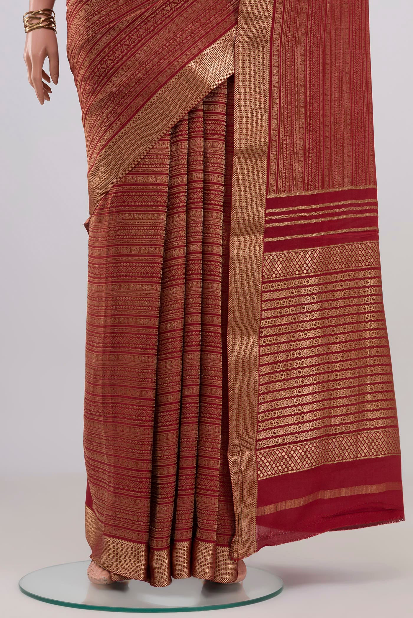 Pleats and pallu of Maroon Mysore Crepe Saree with Zari Brocade on the body and Zari Border. 