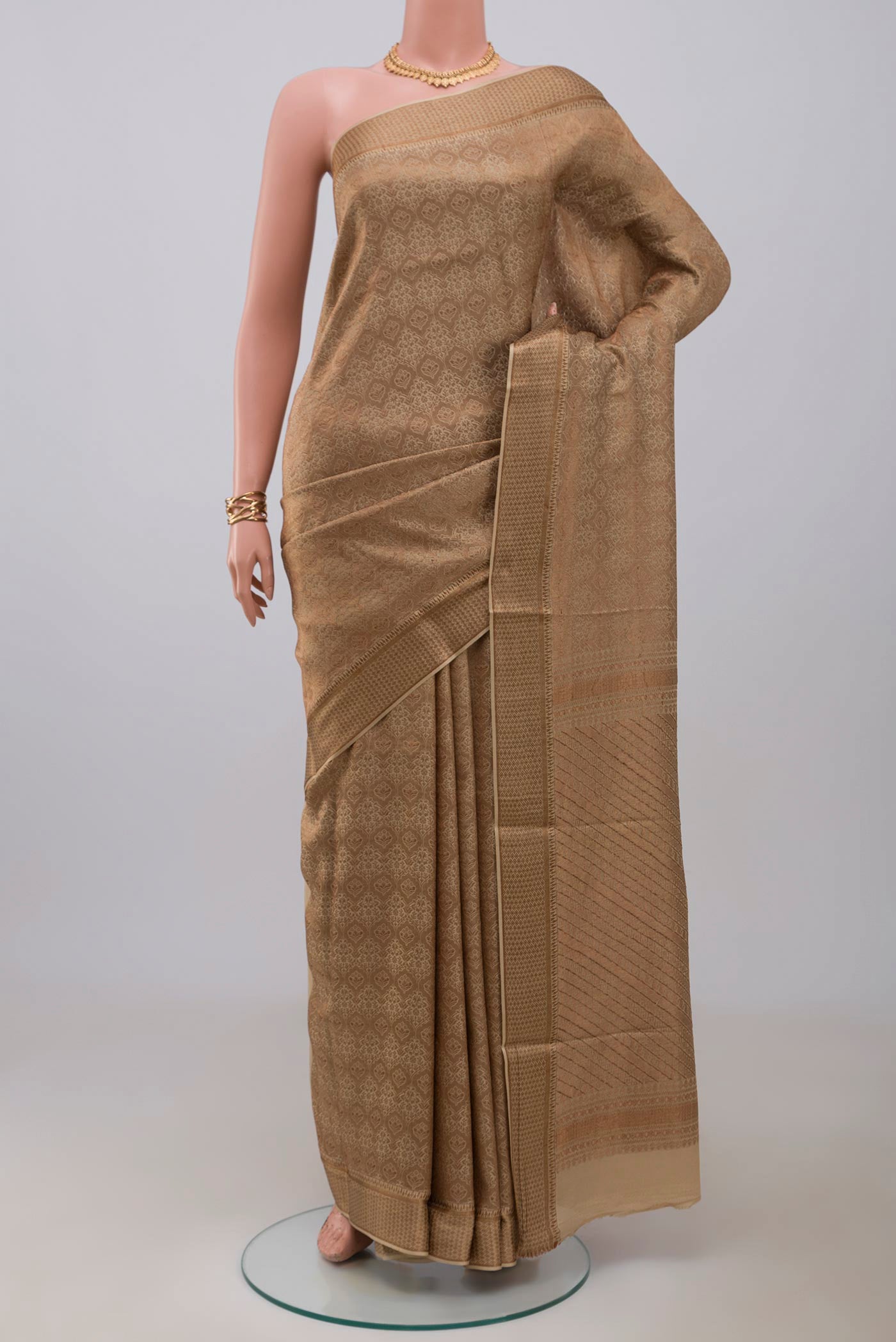 Beige Mysore Crepe Saree with Zari Brocade on the body and Zari Border.  displayed on a mannequin