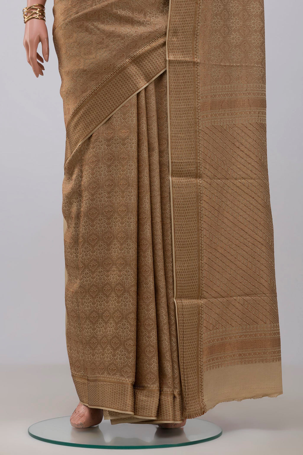 Pleats and pallu of Beige Mysore Crepe Saree with Zari Brocade on the body and Zari Border. 