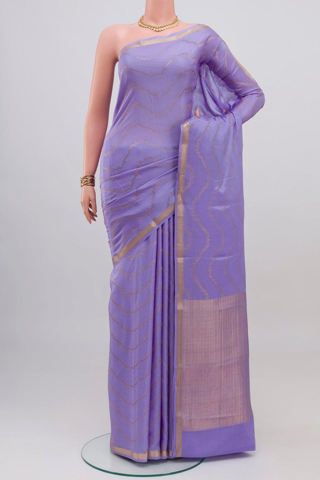 Lavender Mysore Crepe Saree with Zig Zag design on the body and Thin Zari Line.  displayed on a mannequin