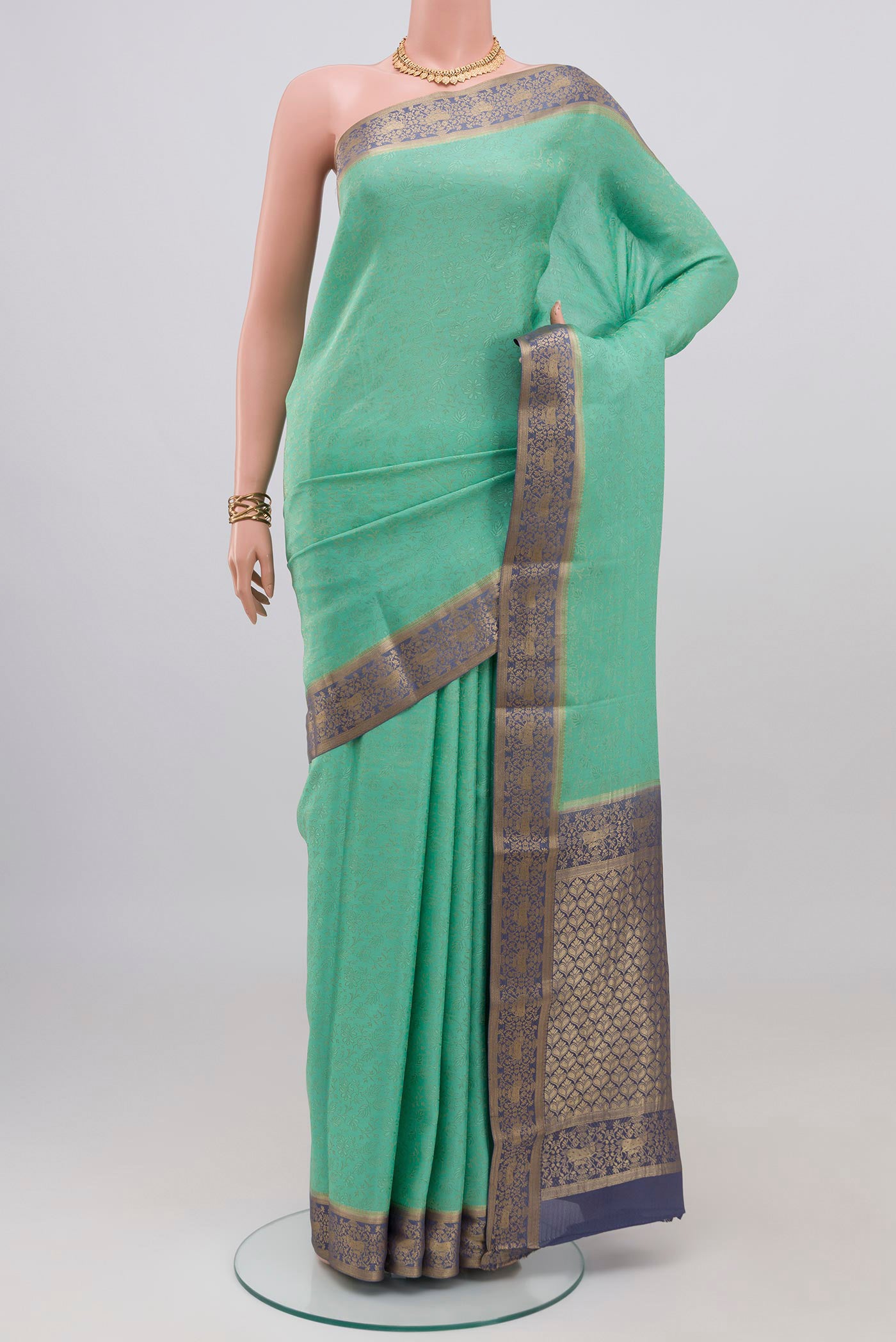 Sea Green Mysore Crepe Saree with Zari Brocade on the body and Zari Border.  displayed on a mannequin