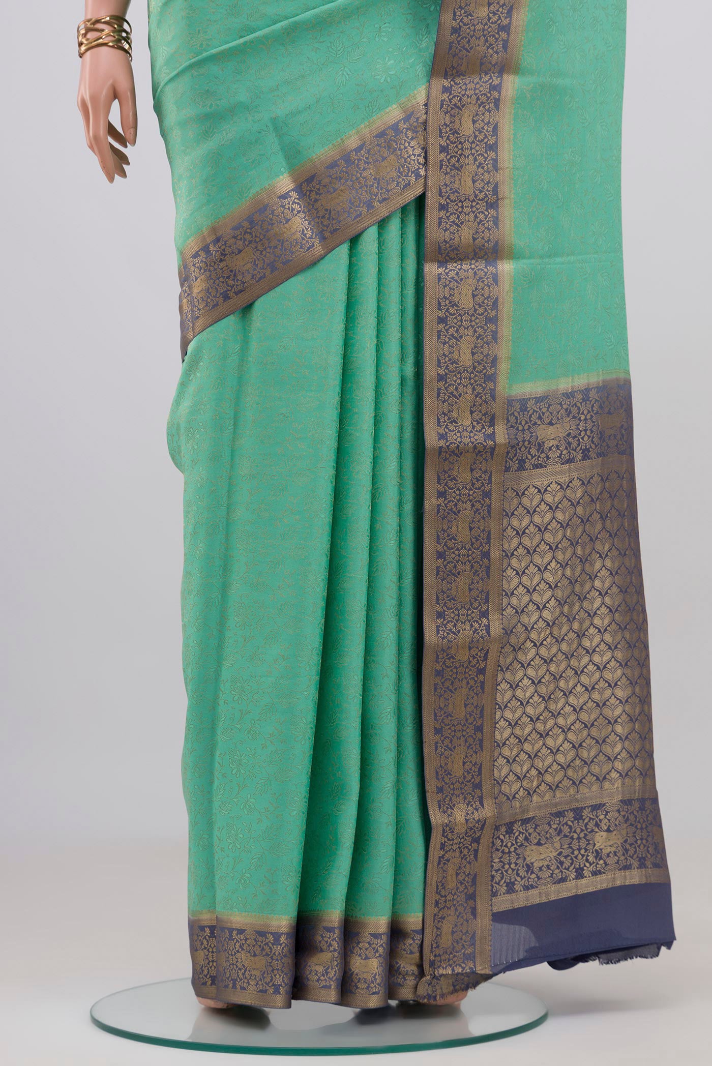 Pleats and pallu of Sea Green Mysore Crepe Saree with Zari Brocade on the body and Zari Border. 