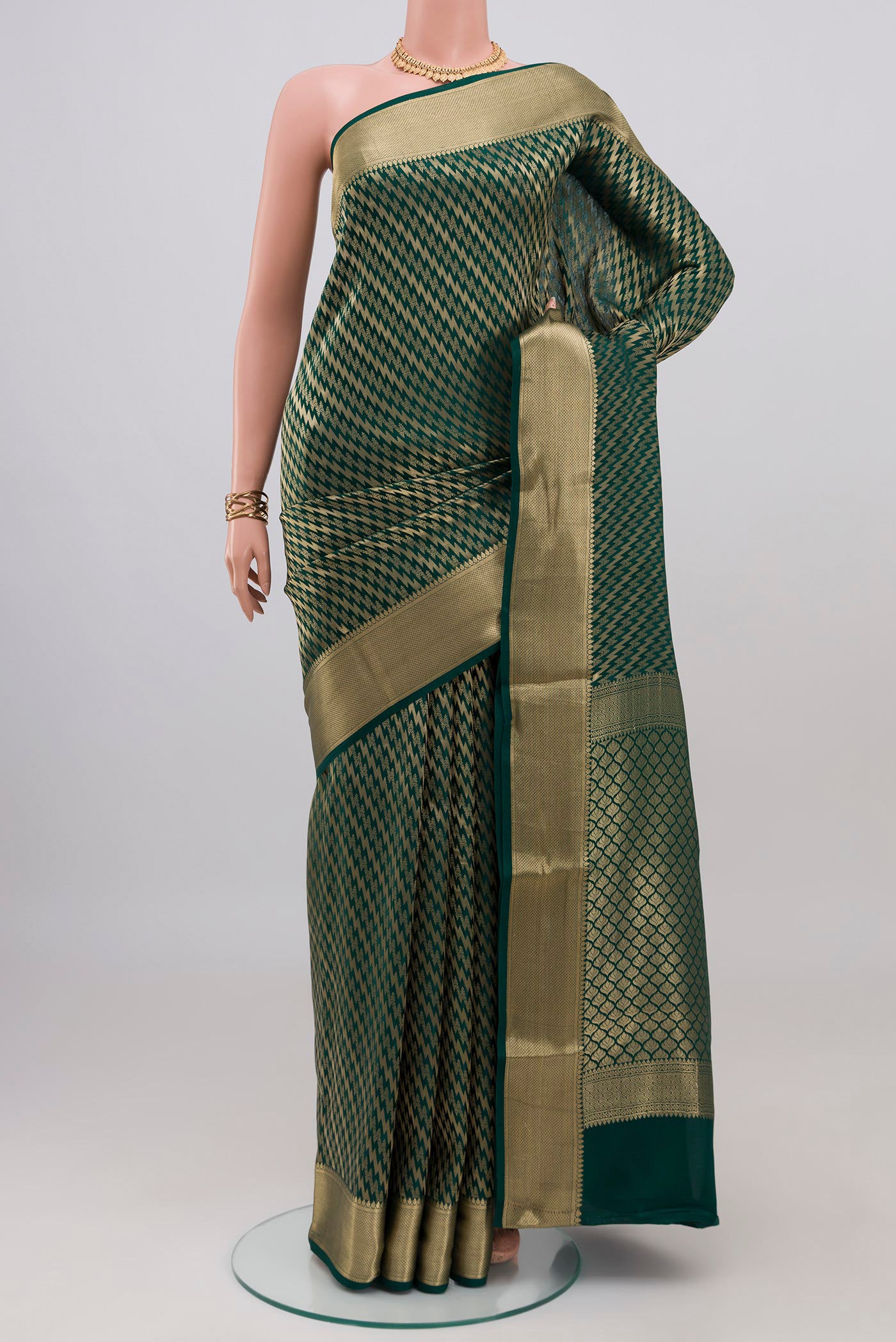 Bottle Green Crepe Saree with Zari Brocade on the body and Zari Border.  displayed on a mannequin
