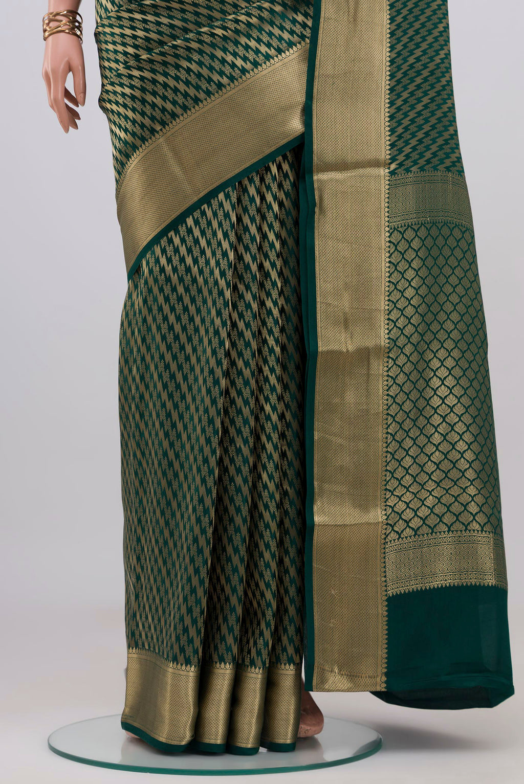Pleats and pallu of Bottle Green Crepe Saree with Zari Brocade on the body and Zari Border. 