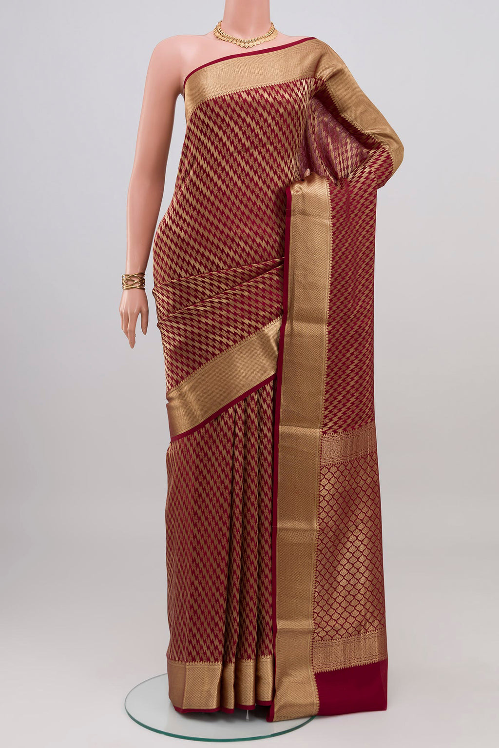 Maroon Mysore Crepe Saree with Zari Brocade on the body and Zari Border.  displayed on a mannequin