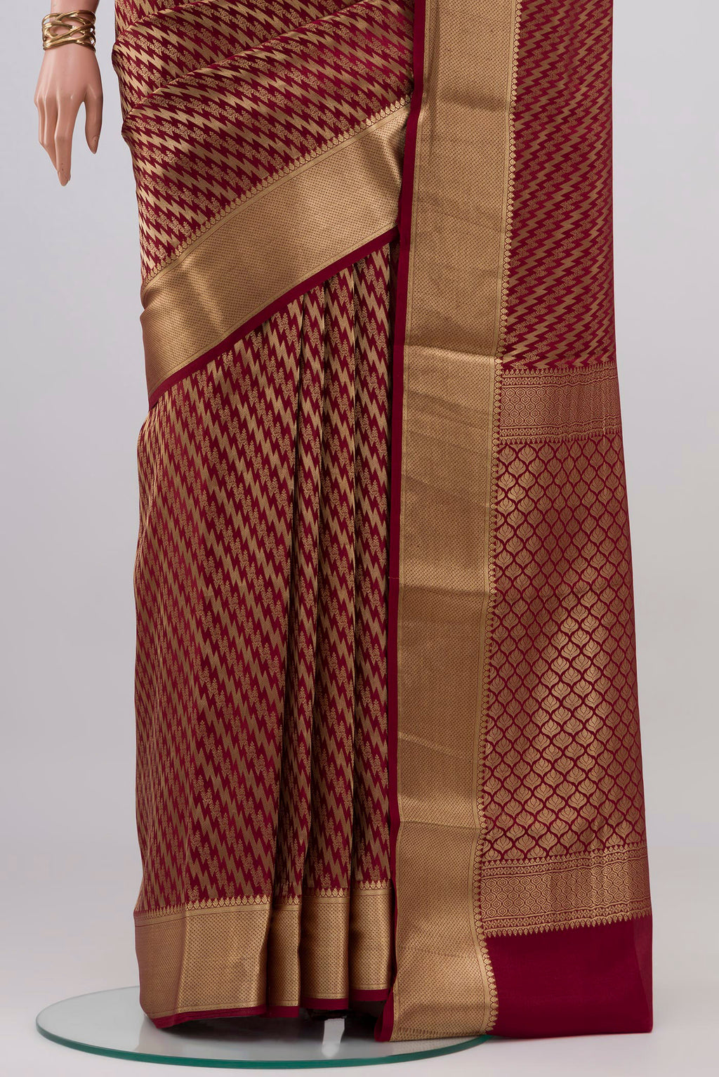 Pleats and pallu of Maroon Mysore Crepe Saree with Zari Brocade on the body and Zari Border. 