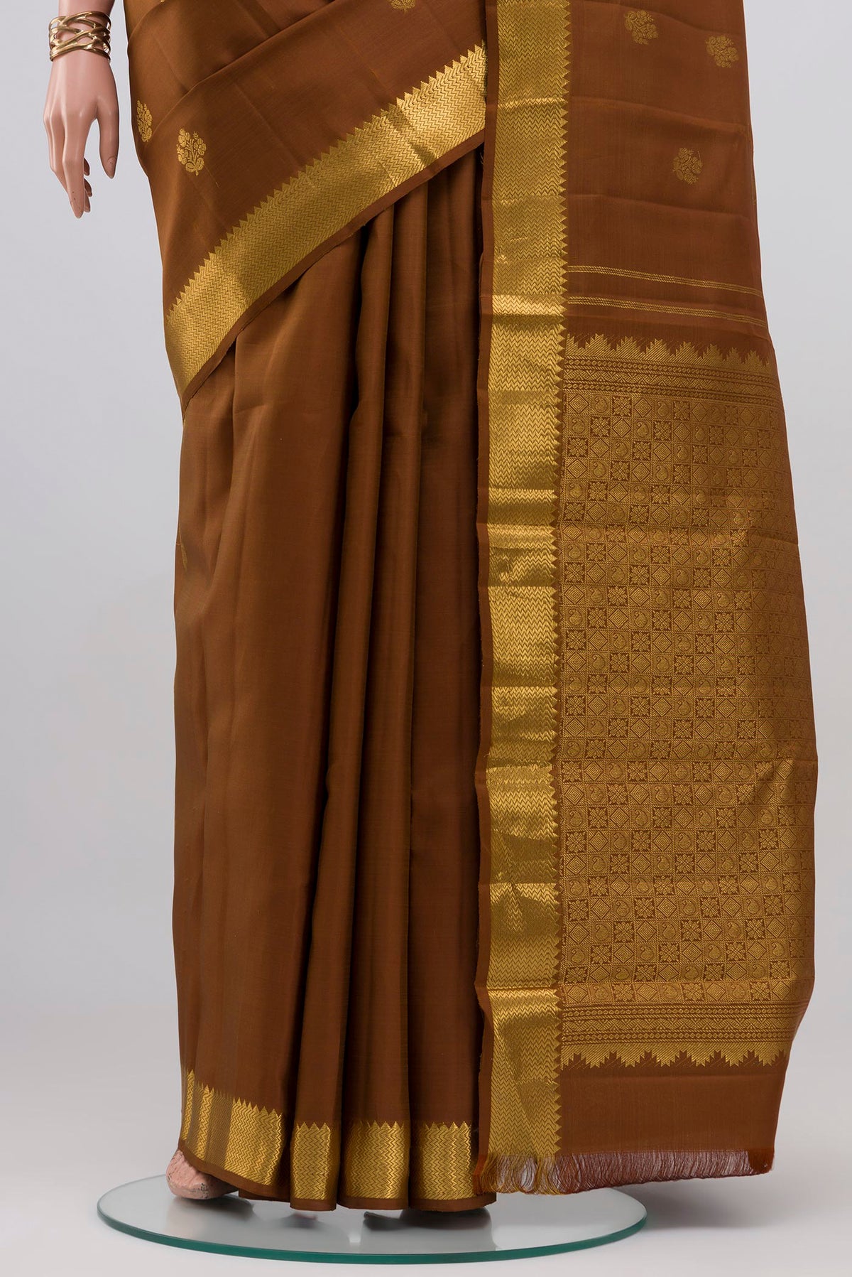 Pleats and pallu of Brown Kanjivaram Silk Saree with Zari Butta on the body and Zari Border. 