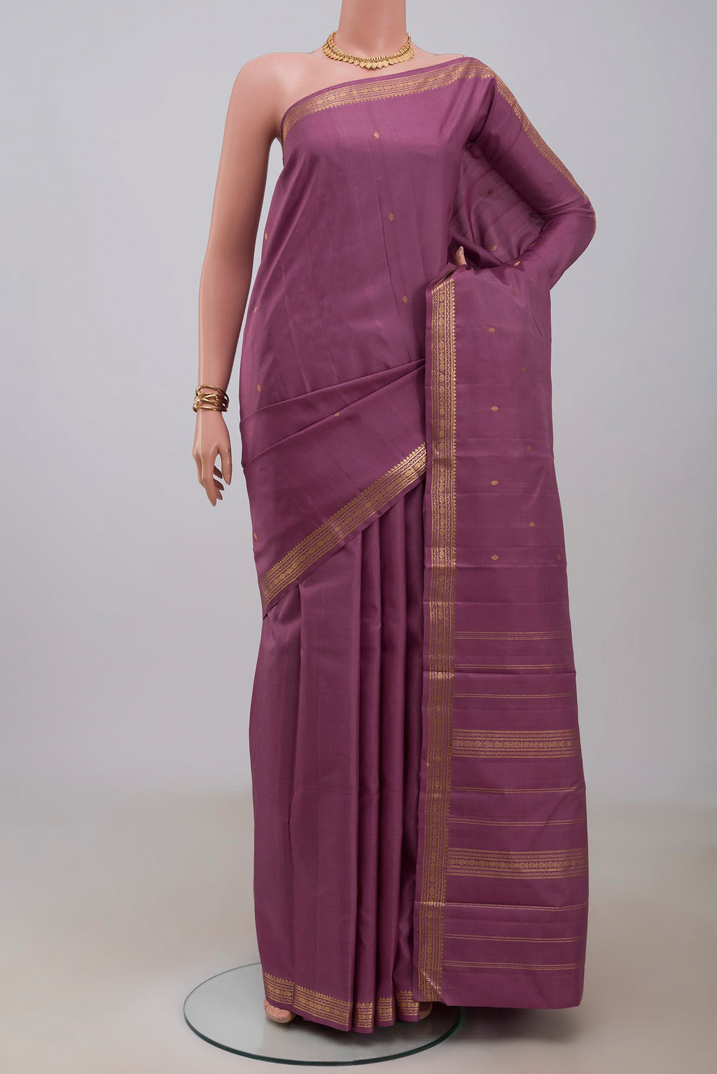 Purple Kanchipuram Silk Saree with Zari Butta on the body and Zari Border.  displayed on a mannequin