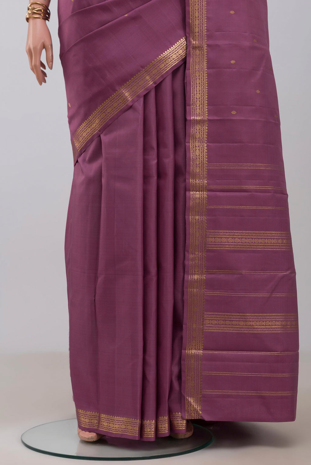 Pleats and pallu of Purple Kanchipuram Silk Saree with Zari Butta on the body and Zari Border. 
