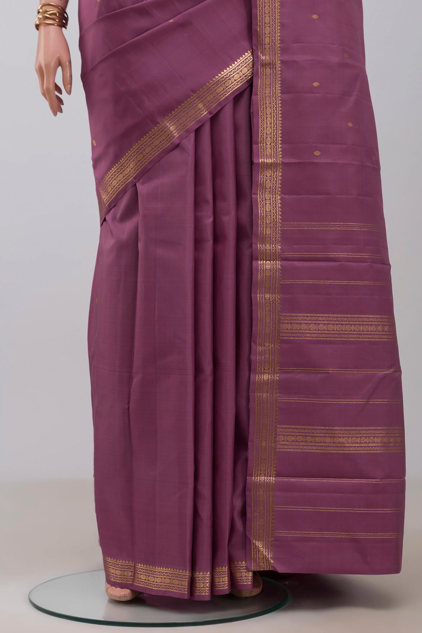 Pleats and pallu of Purple Kanchipuram Silk Saree with Zari Butta on the body and Zari Border. 