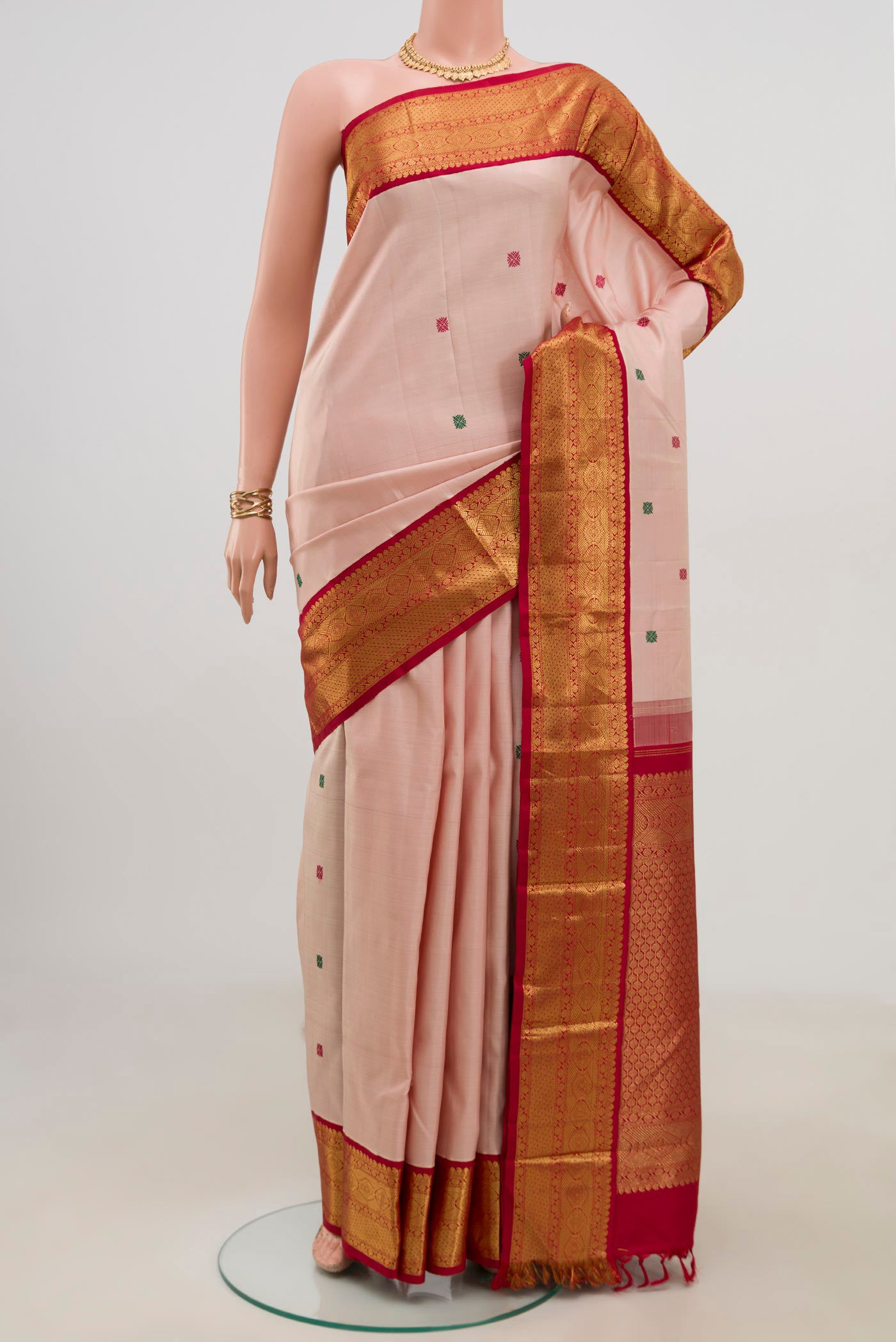 Pure Silk Pure Zari Peach Kanjivaram Saree with Thread Butta on the body and Zari Border.  displayed on a mannequin