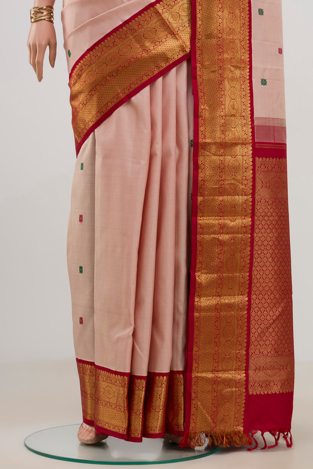 Pleats and pallu of Pure Silk Pure Zari Peach Kanjivaram Saree with Thread Butta on the body and Zari Border. 