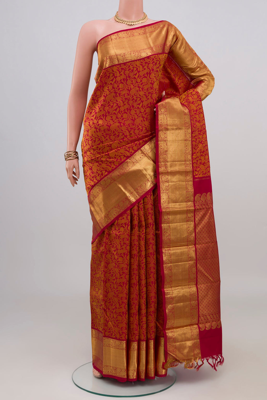 Red Kanjivaram Silk Saree with Jacquard design on the body and Zari Border.  displayed on a mannequin