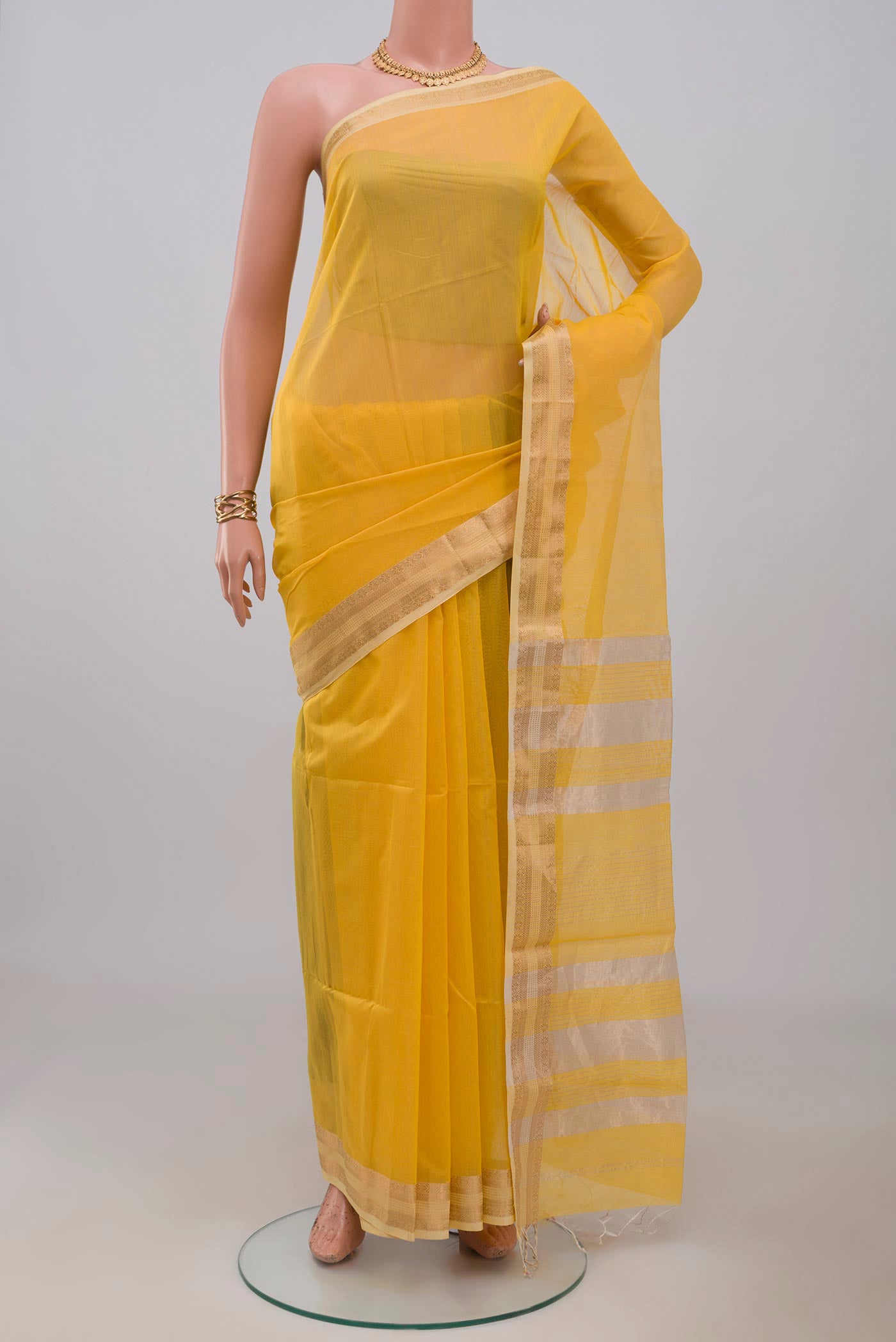 Yellow Maheshwari Silk Cotton Saree with Plain Body and Zari Border.  displayed on a mannequin