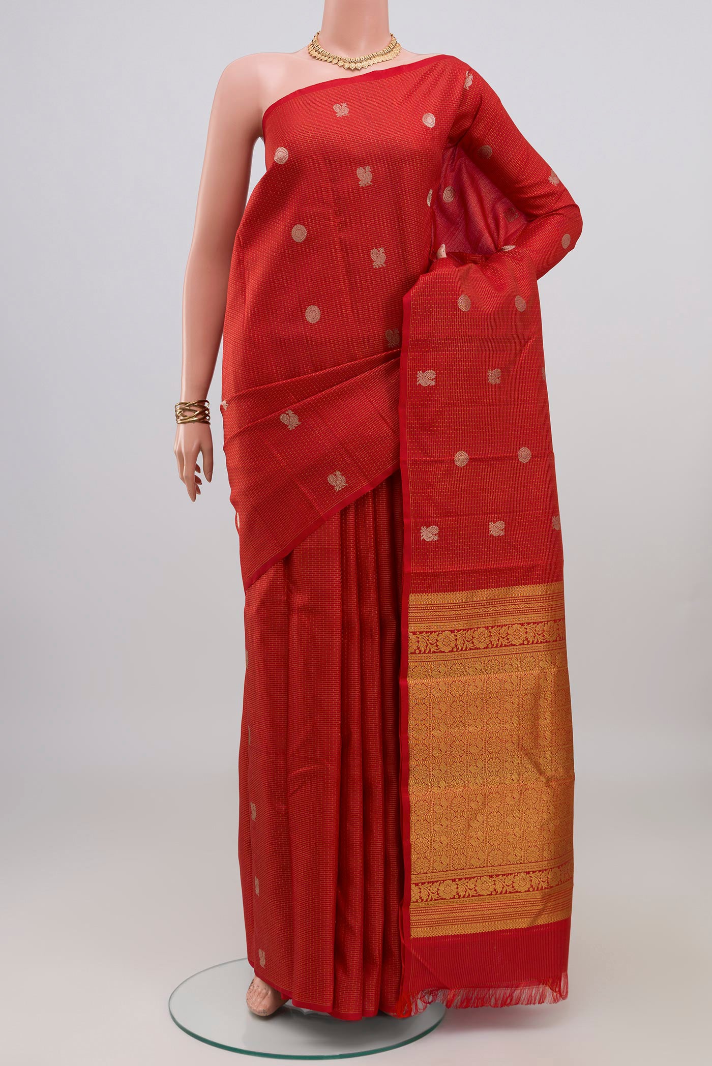 Red Kanchipuram Silk Saree with Checked design on the body and Without Border.  displayed on a mannequin