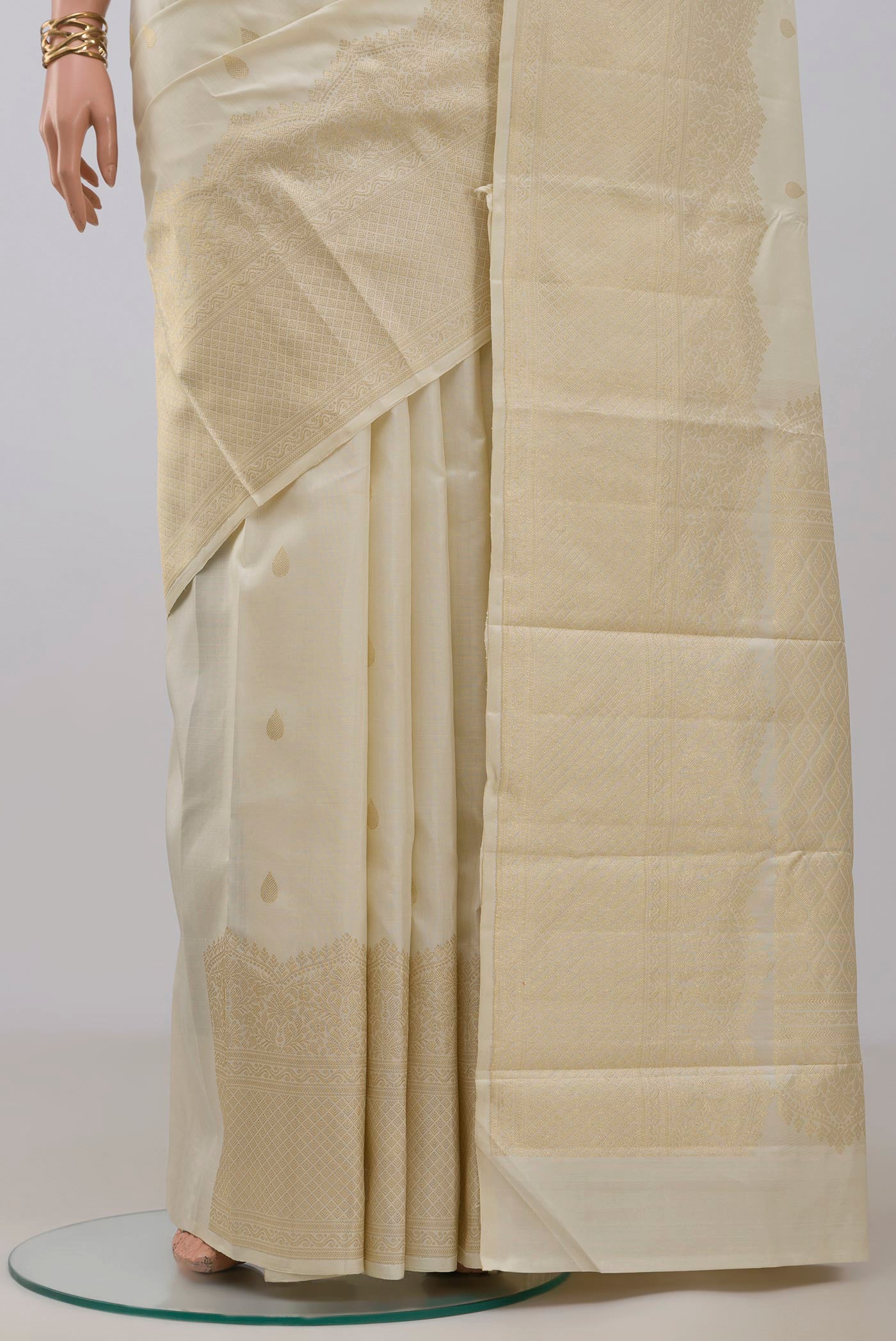 Pleats and pallu of Off White Kanjivaram Silk Saree with Zari Butta on the body and Zari Border. 
