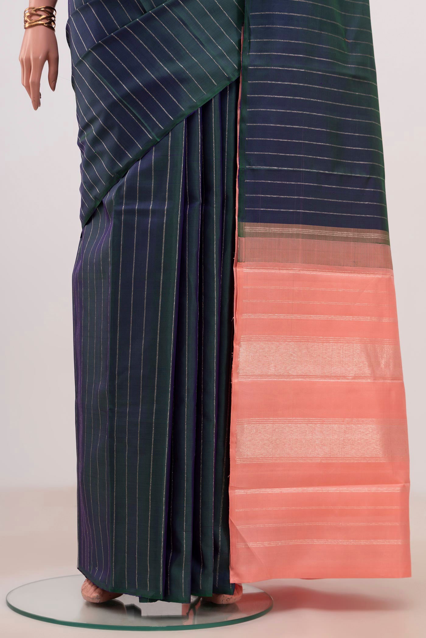 Pleats and pallu of Peacock Blue Kanjivaram Silk Saree with Stripes on the body and Without Border. 