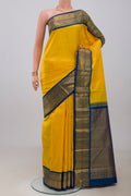 Yellow Kanjivaram Silk Saree with Zari Butta on the body and Zari Border.  displayed on a mannequin