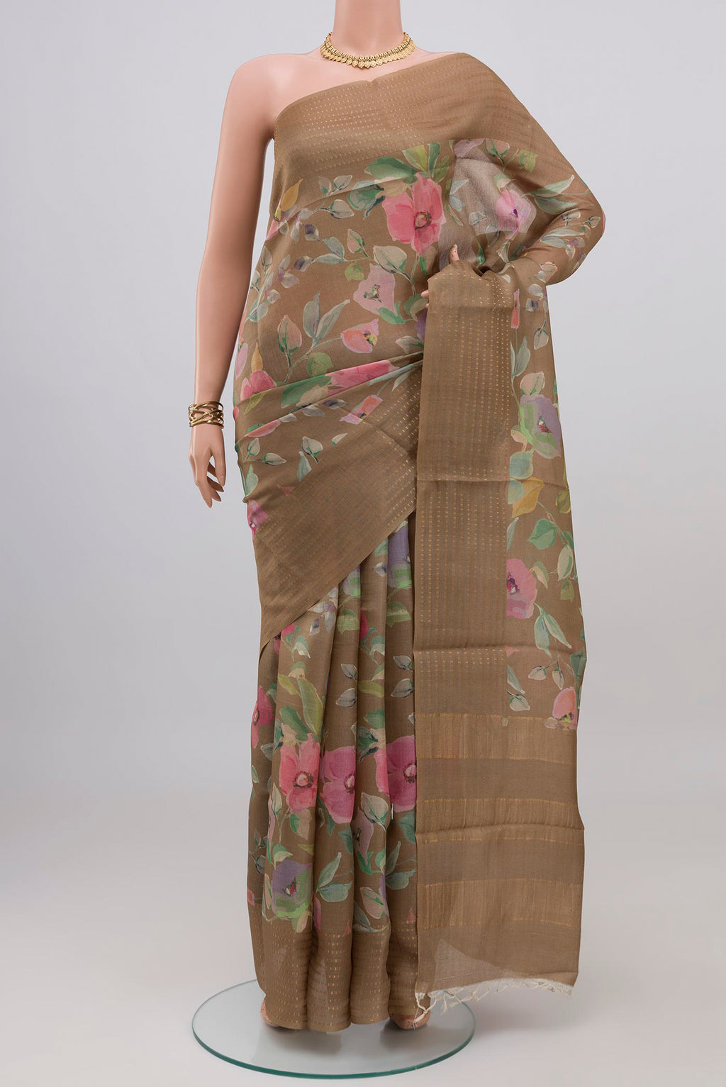 Beige Tussar Silk Saree with Floral Print on the body and Thin Zari Line.  displayed on a mannequin