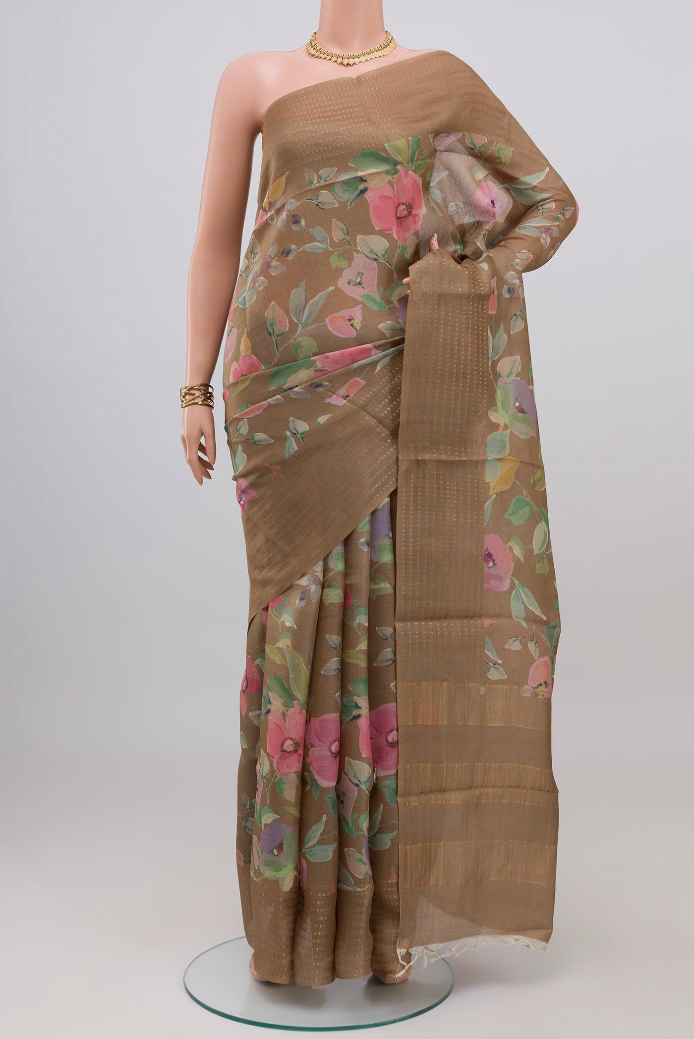 Beige Tussar Silk Saree with Floral Print on the body and Thin Zari Line.  displayed on a mannequin