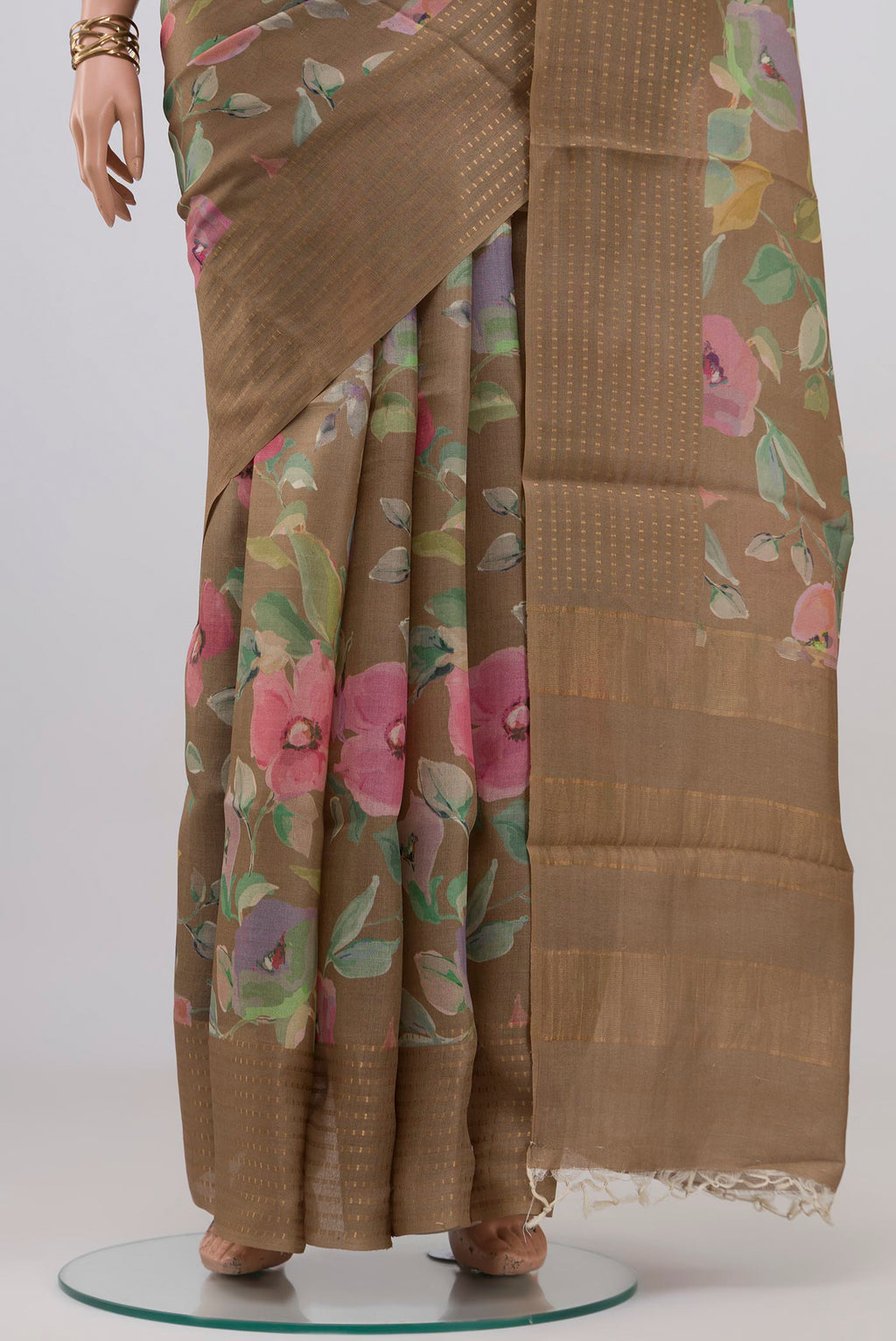 Pleats and pallu of Beige Tussar Silk Saree with Floral Print on the body and Thin Zari Line. 