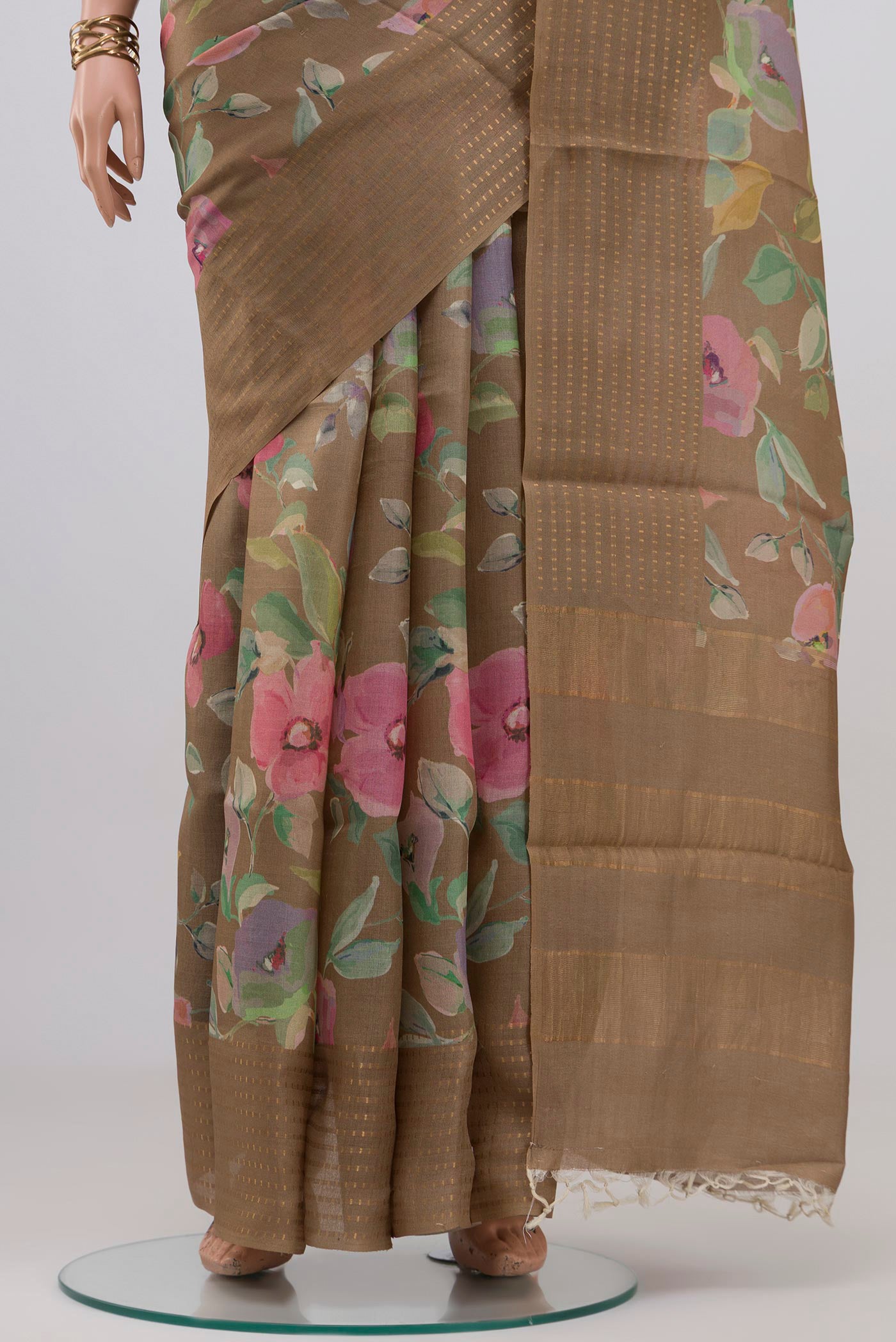 Pleats and pallu of Beige Tussar Silk Saree with Floral Print on the body and Thin Zari Line. 