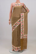 Mehandi Green Tussar Silk Saree with Printed design on the body and Printed Border.  displayed on a mannequin