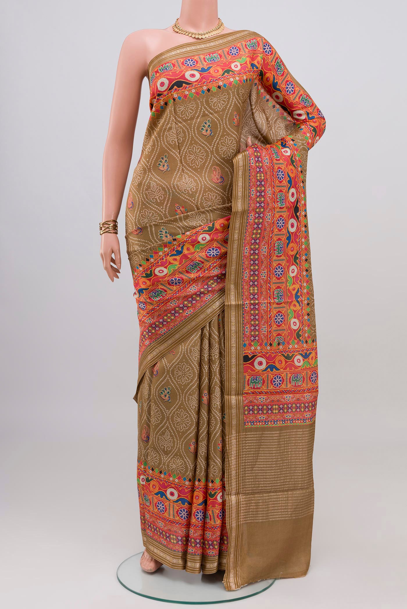Beige Tussar Silk Saree with Printed design on the body and Printed Border.  displayed on a mannequin