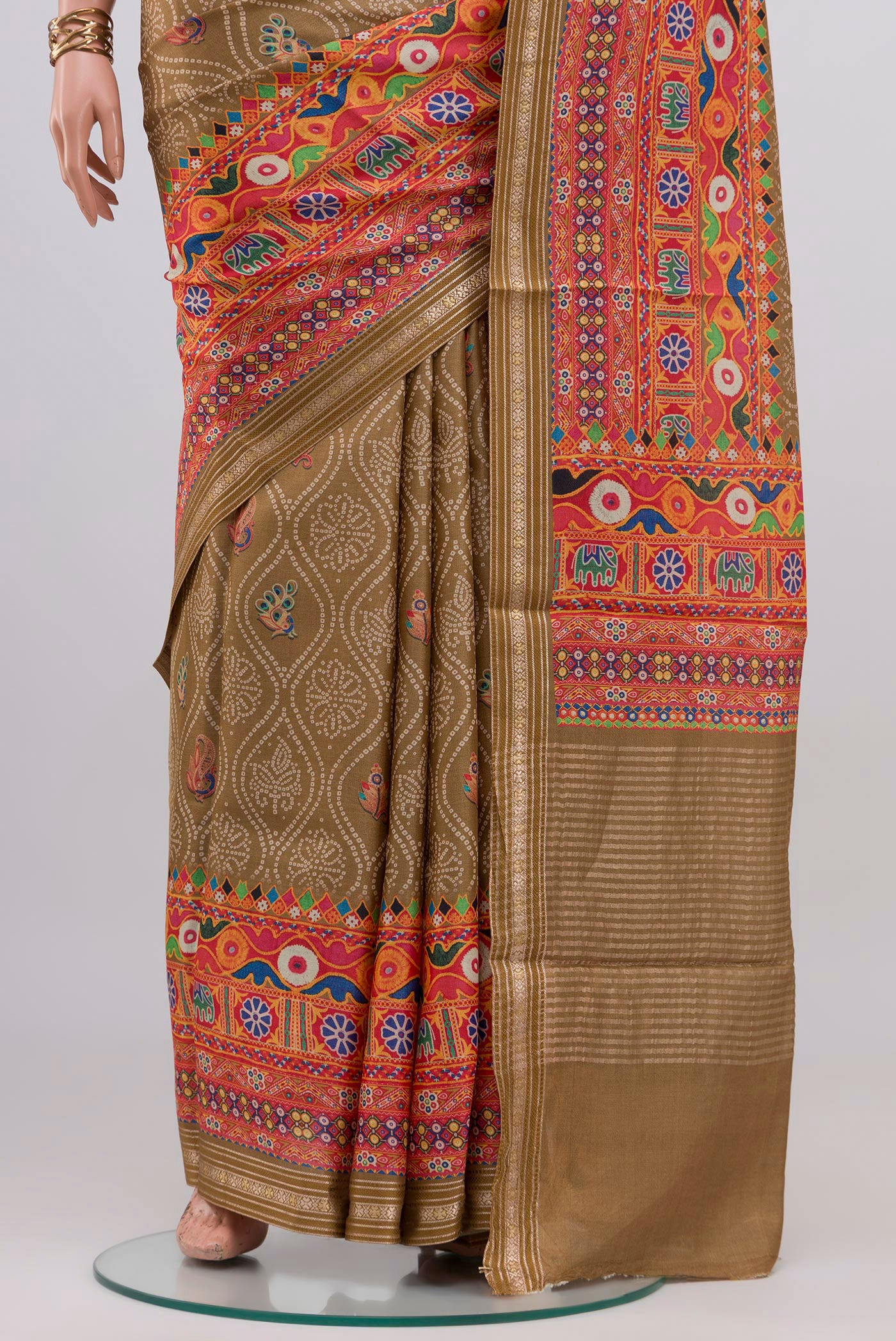 Pleats and pallu of Beige Tussar Silk Saree with Printed design on the body and Printed Border. 