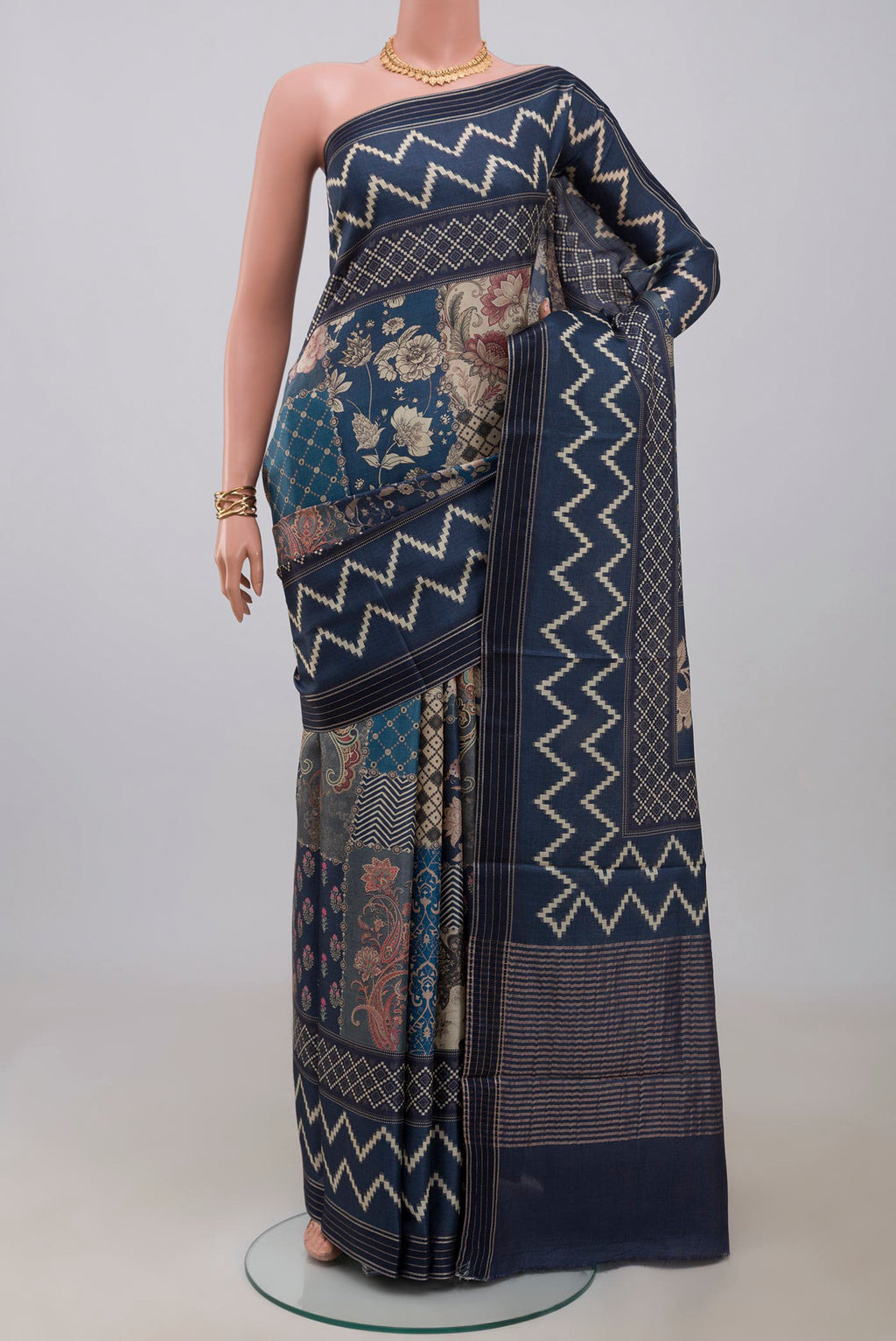 Blue Tussar Saree with Printed design on the body and Printed Border.  displayed on a mannequin