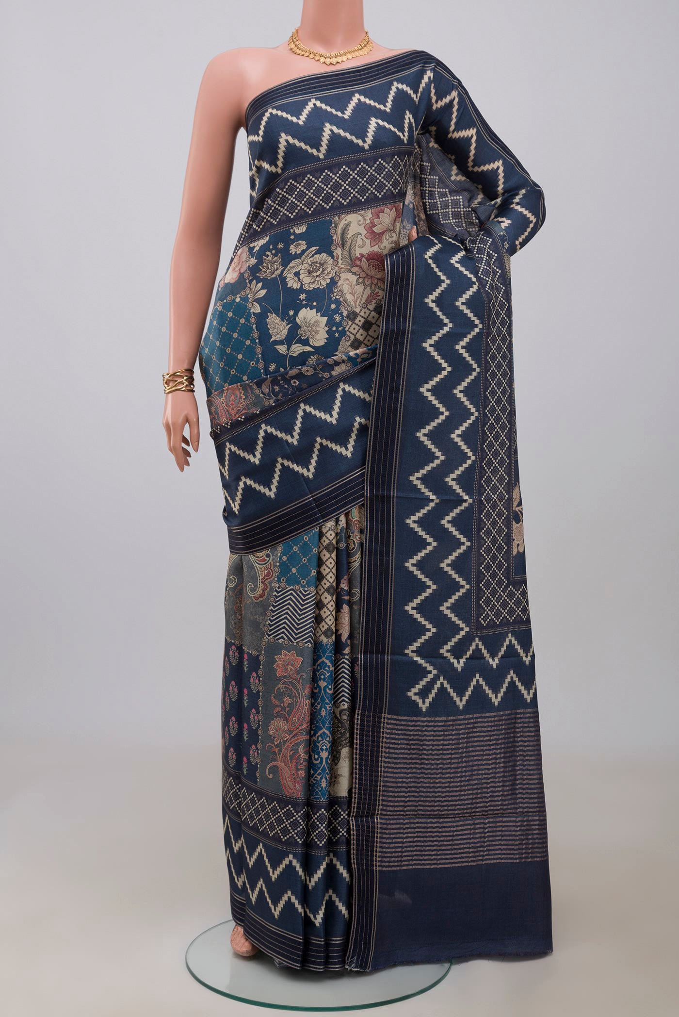 Blue Tussar Saree with Printed design on the body and Printed Border.  displayed on a mannequin