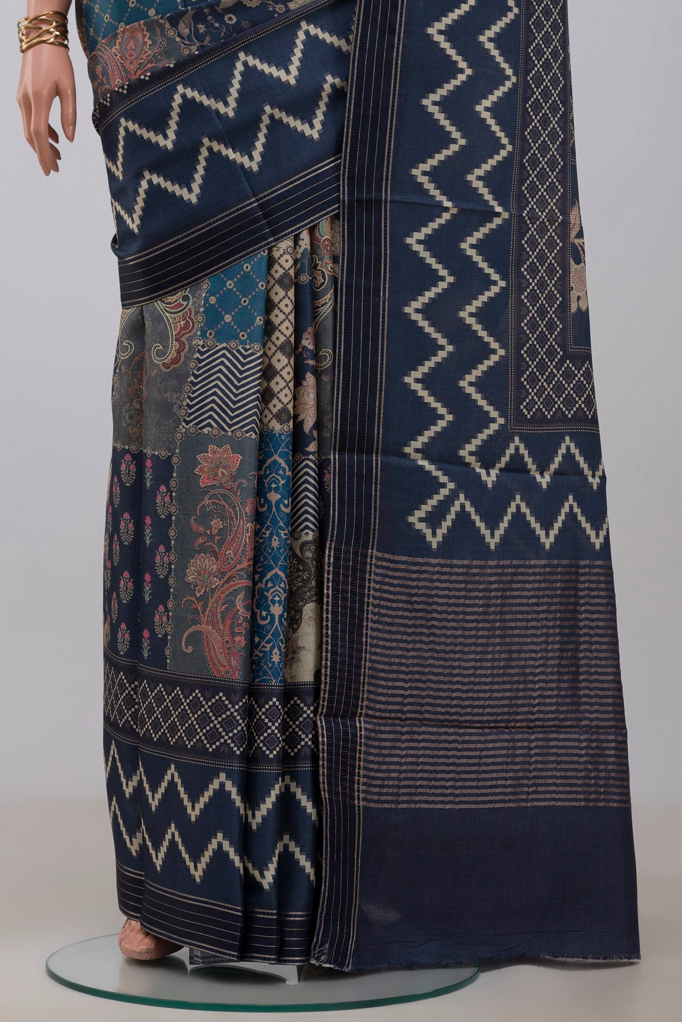 Pleats and pallu of Blue Tussar Saree with Printed design on the body and Printed Border. 