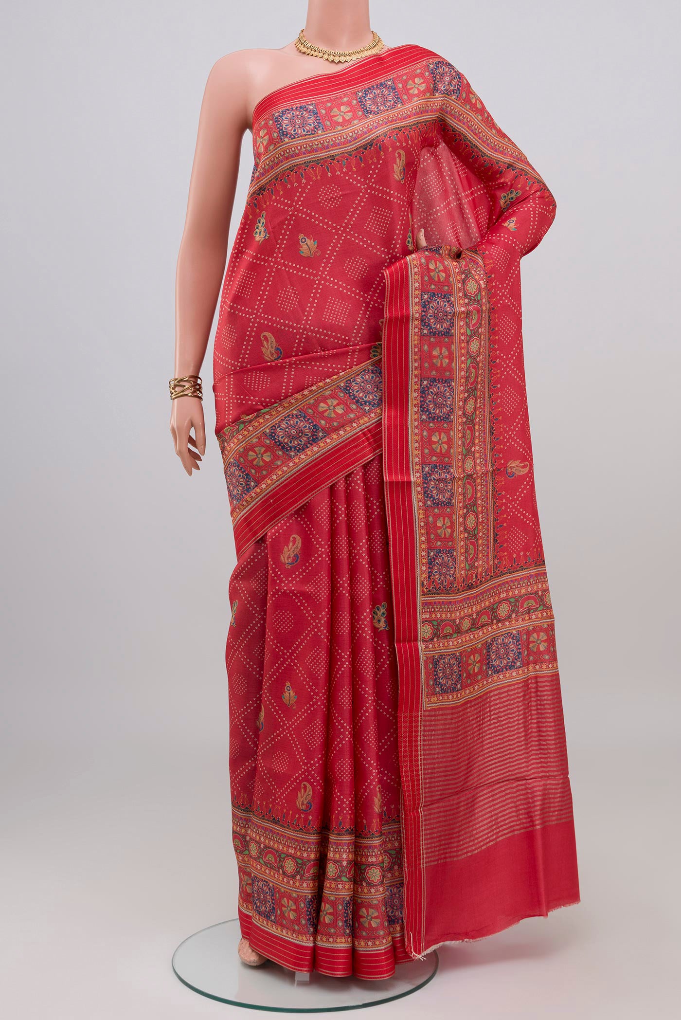 Red Tussar Silk Saree with Printed design on the body and Printed Border.  displayed on a mannequin