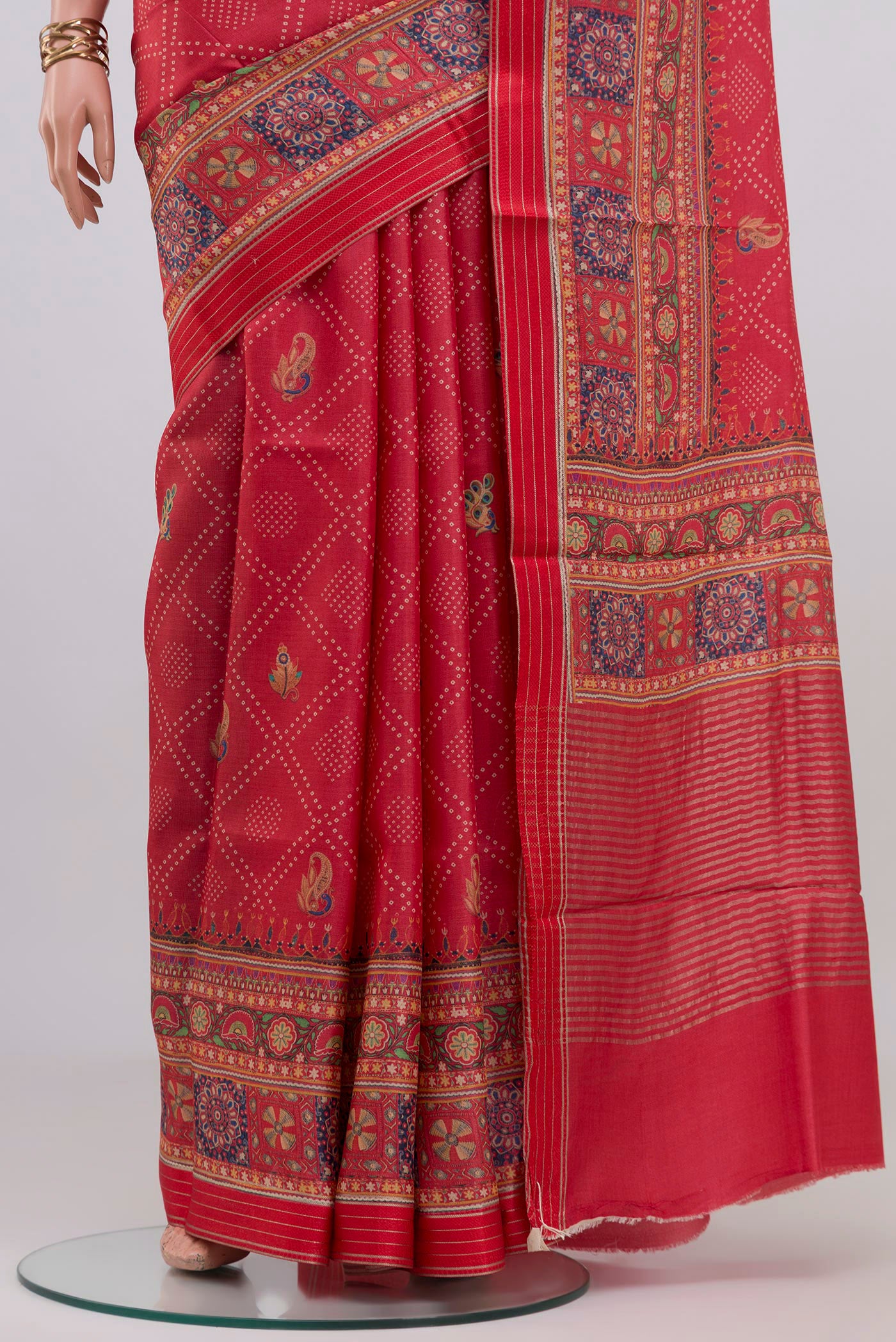 Pleats and pallu of Red Tussar Silk Saree with Printed design on the body and Printed Border. 