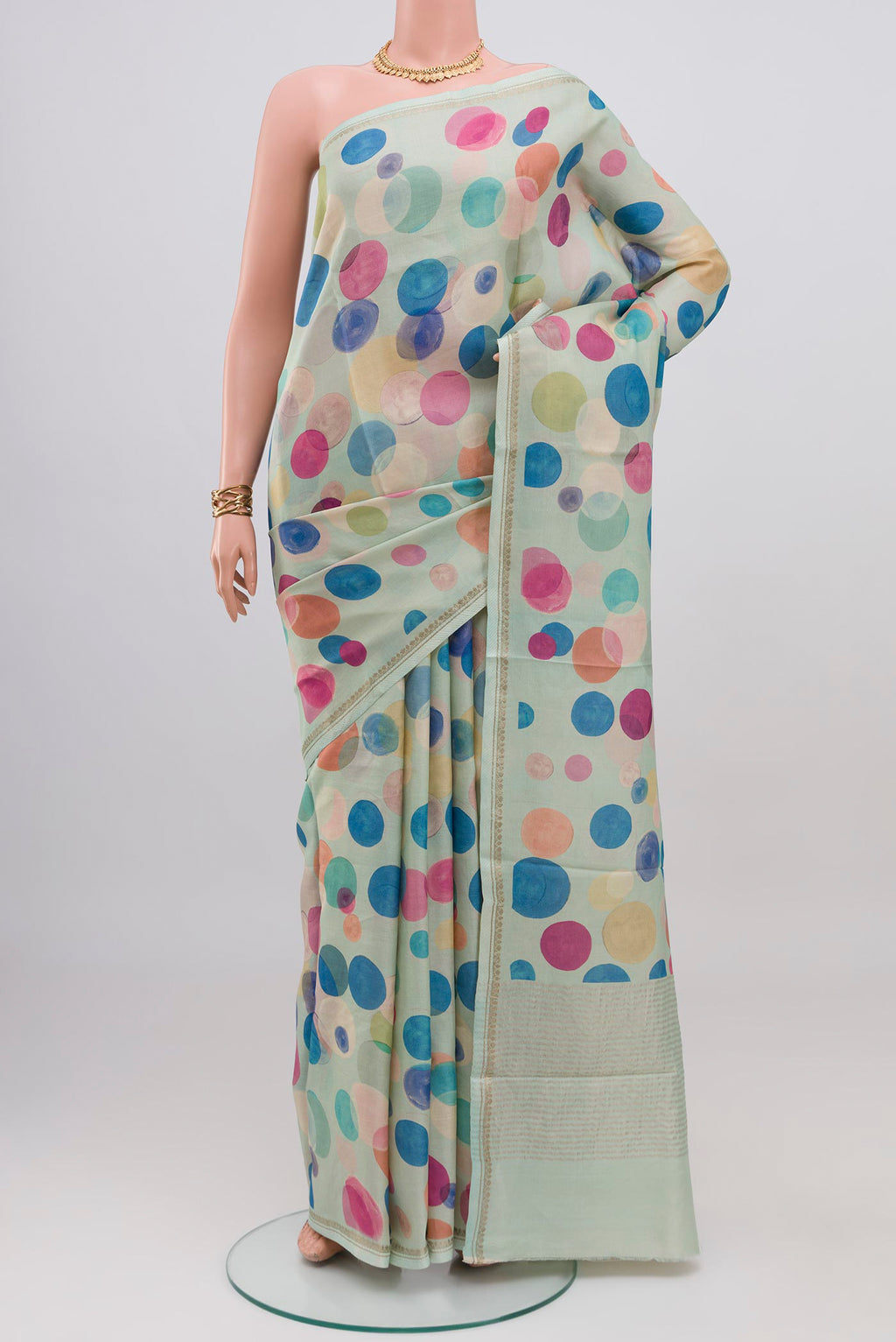 Light Blue Tussar Silk Saree with Printed design on the body and Thin Zari Line.  displayed on a mannequin