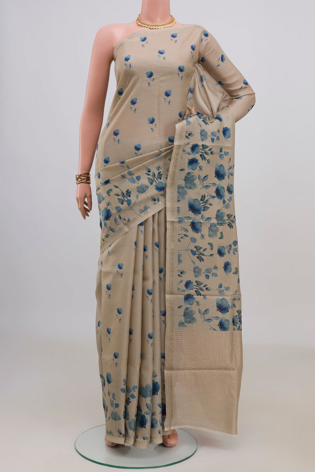 Cream Tussar Saree with Floral Print on the body and Thin Zari Line.  displayed on a mannequin