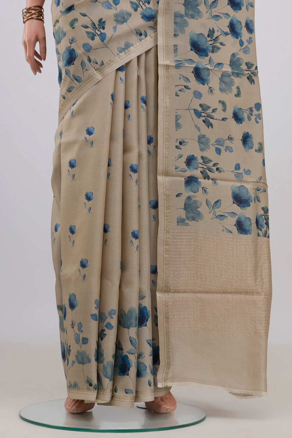 Pleats and pallu of Cream Tussar Saree with Floral Print on the body and Thin Zari Line. 