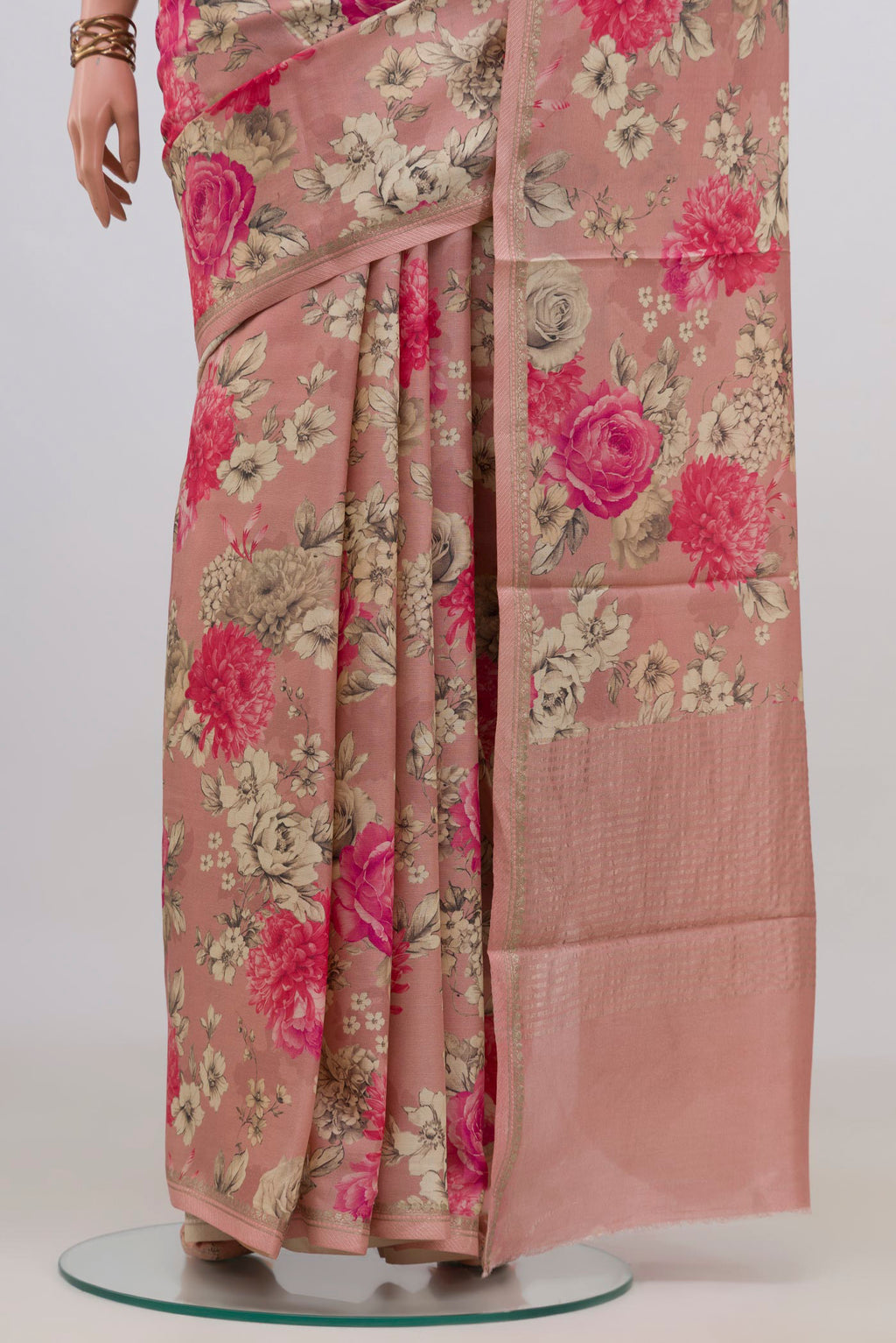 Pleats and pallu of Peach Tussar Saree with Floral Print on the body and Zari Border. 