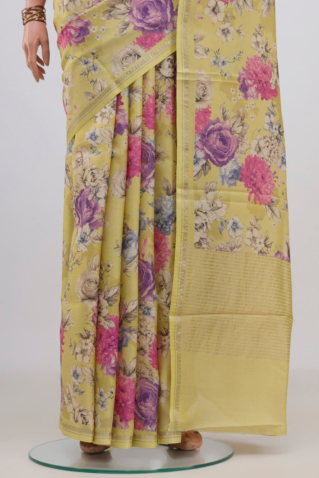Pleats and pallu of Yellow Tussar Saree with Floral Print on the body and Thin Zari Line. 