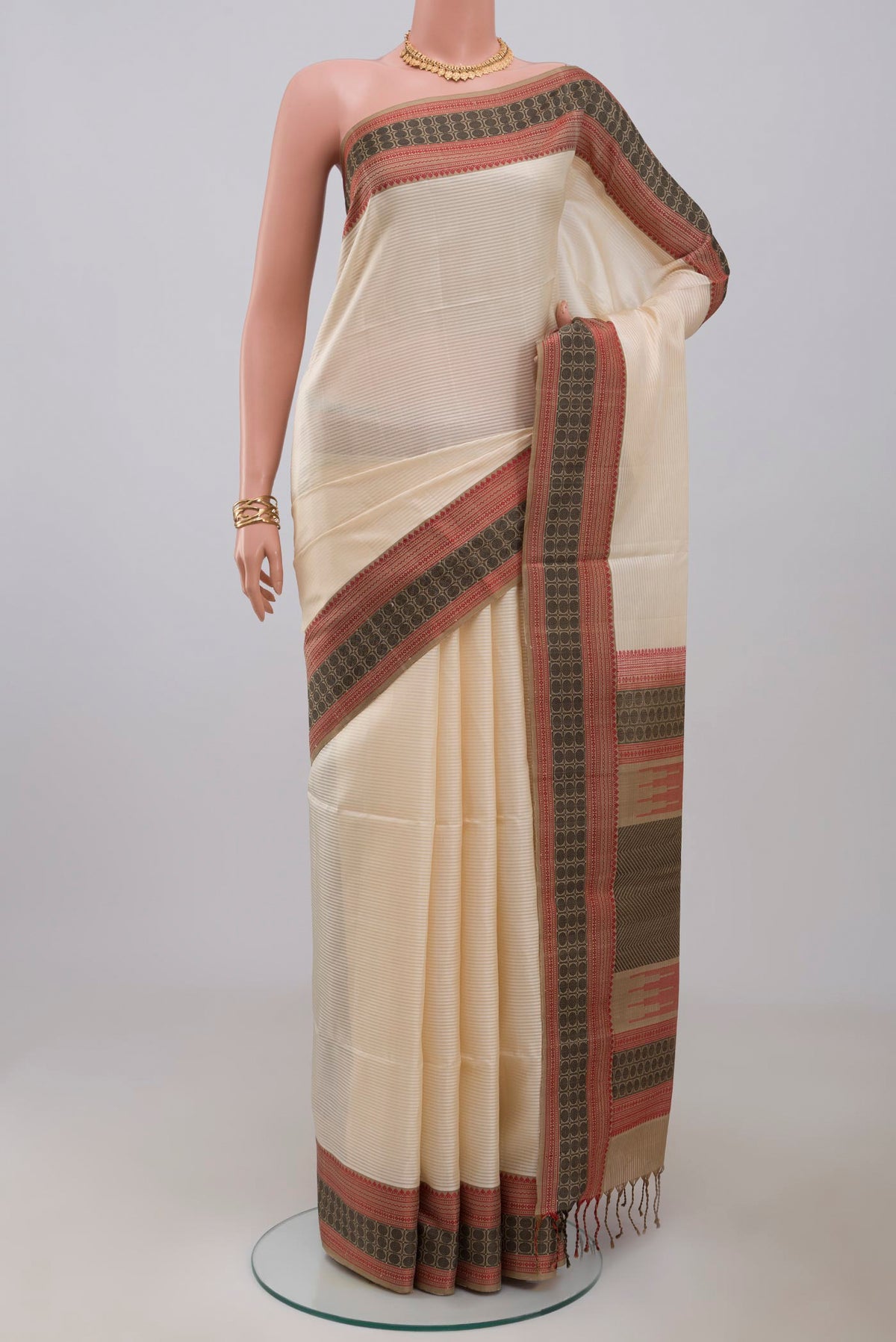 Off White Soft Silk Saree with Plain Body and Thread Border.  displayed on a mannequin