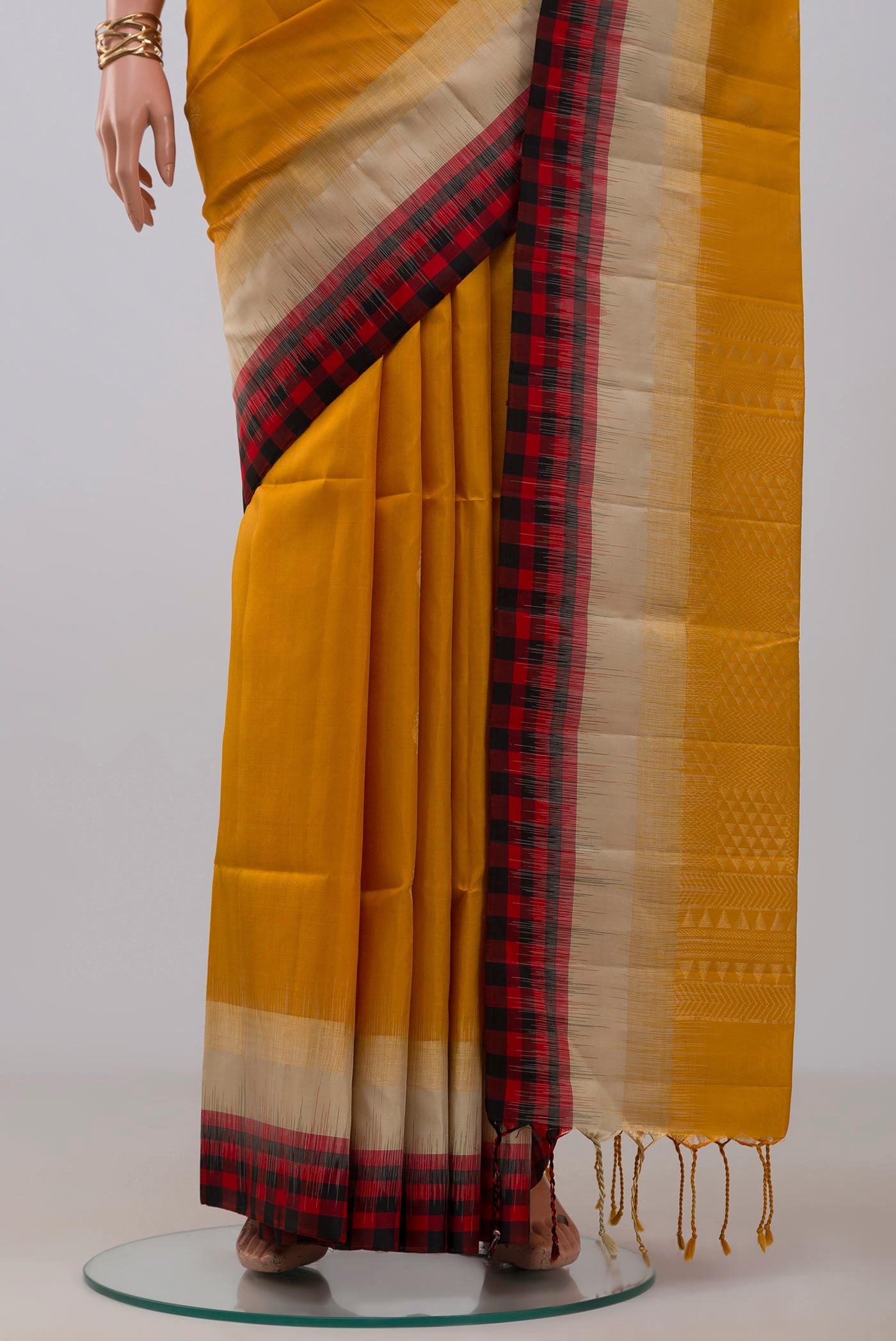 Pleats and pallu of Yellow Soft Silk Saree with Zari Butta on the body and Fancy Border. 