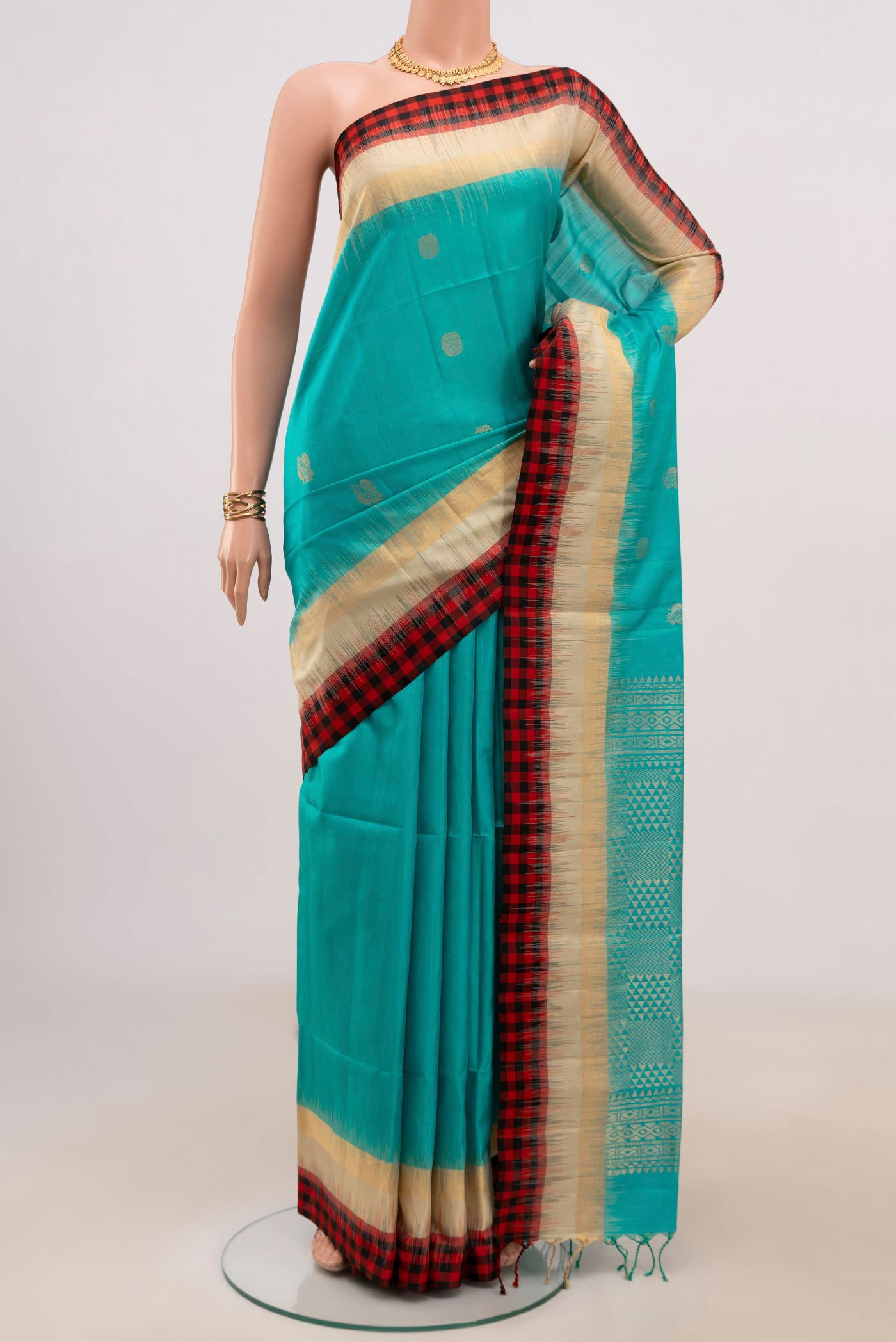 Blue Soft Silk Saree with Zari Butta on the body and Thin Zari Line.  displayed on a mannequin