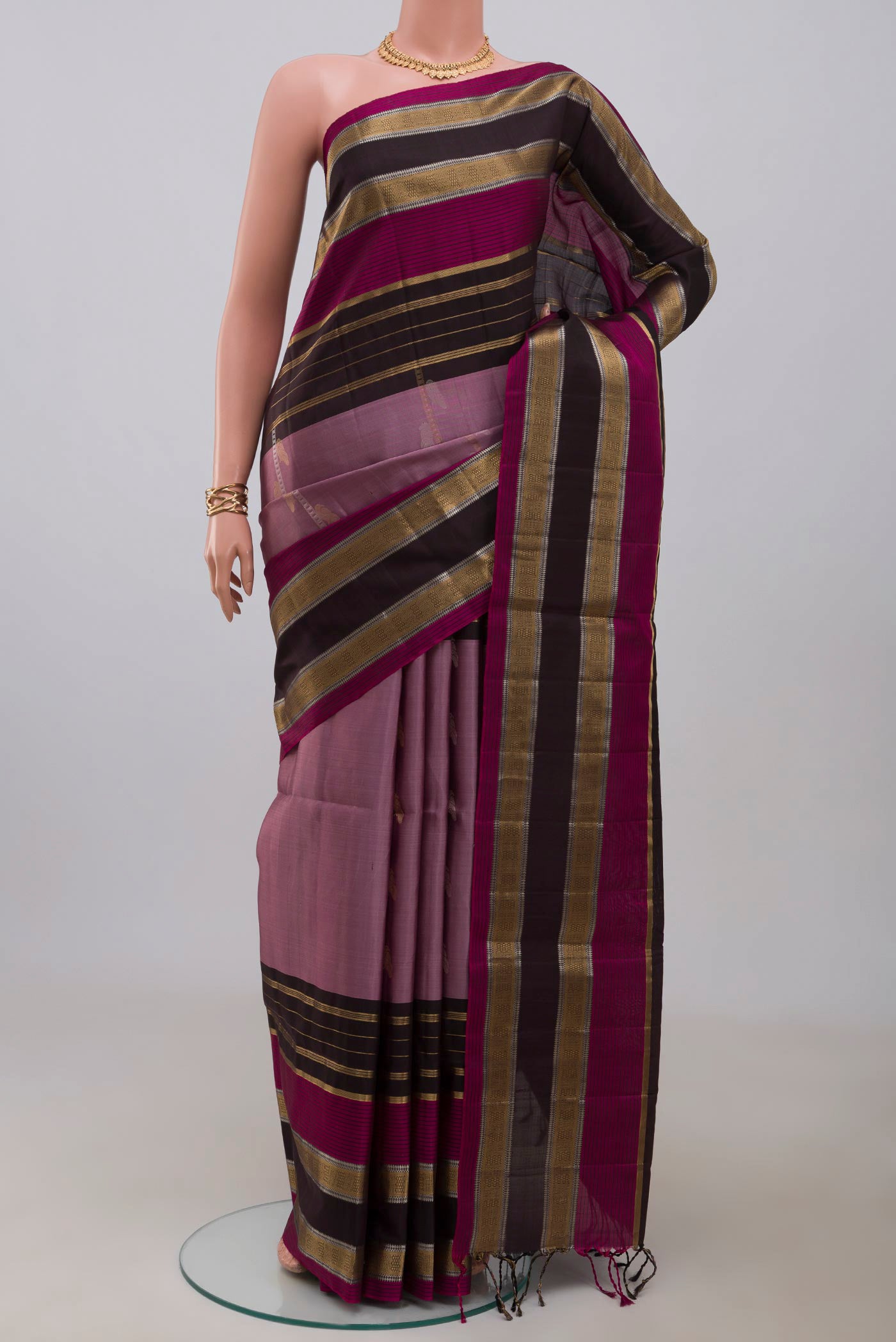 Lavender Soft Silk Saree with Fancy on the body and Fancy Border.  displayed on a mannequin