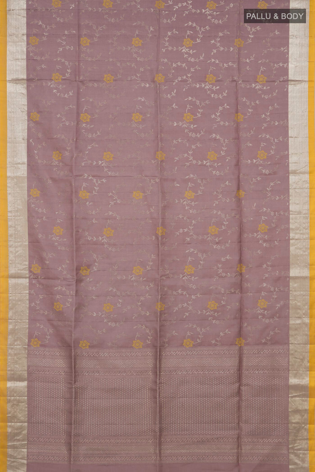 Flat view of Lavender Soft Silk Saree with Zari Butta on the body and Zari Border. 