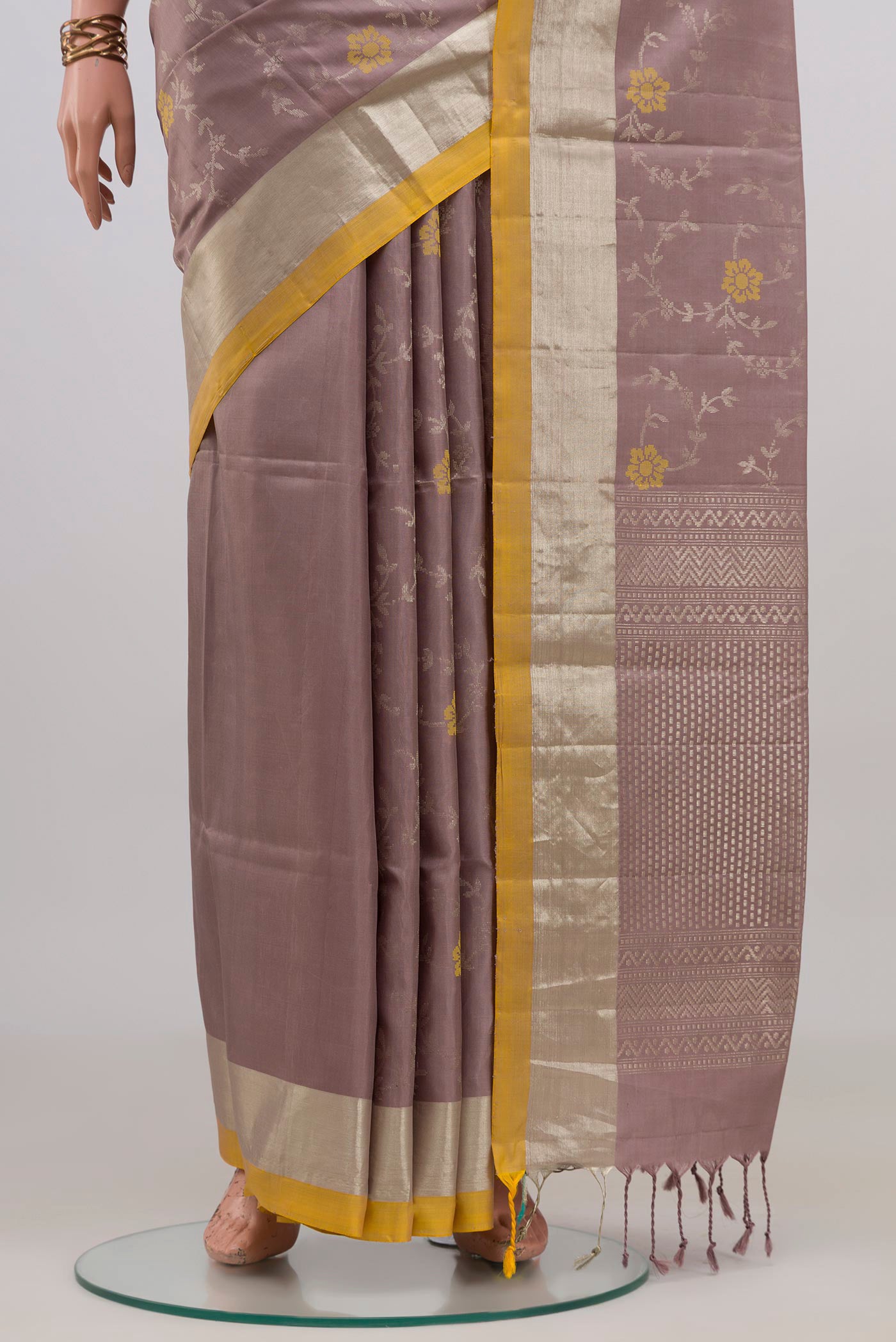 Pleats and pallu of Lavender Soft Silk Saree with Zari Butta on the body and Zari Border. 
