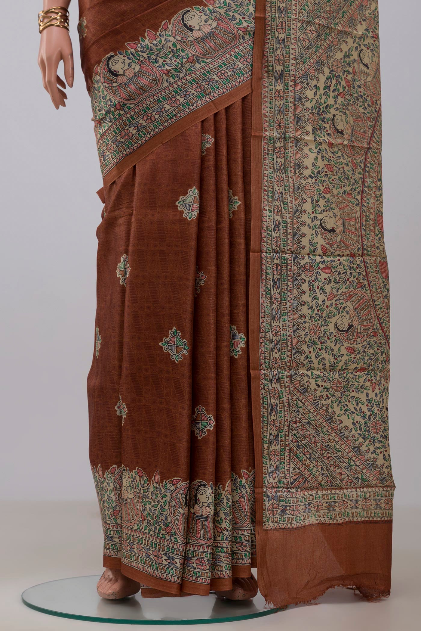 Pleats and pallu of Brown Printed Silk Saree with Printed design on the body and Printed Border. 