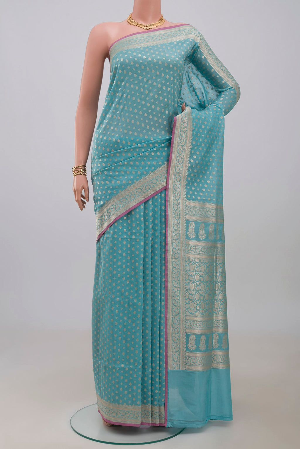 Light Blue Banarasi Silk Saree with Zari Butta on the body and Zari Border.  displayed on a mannequin