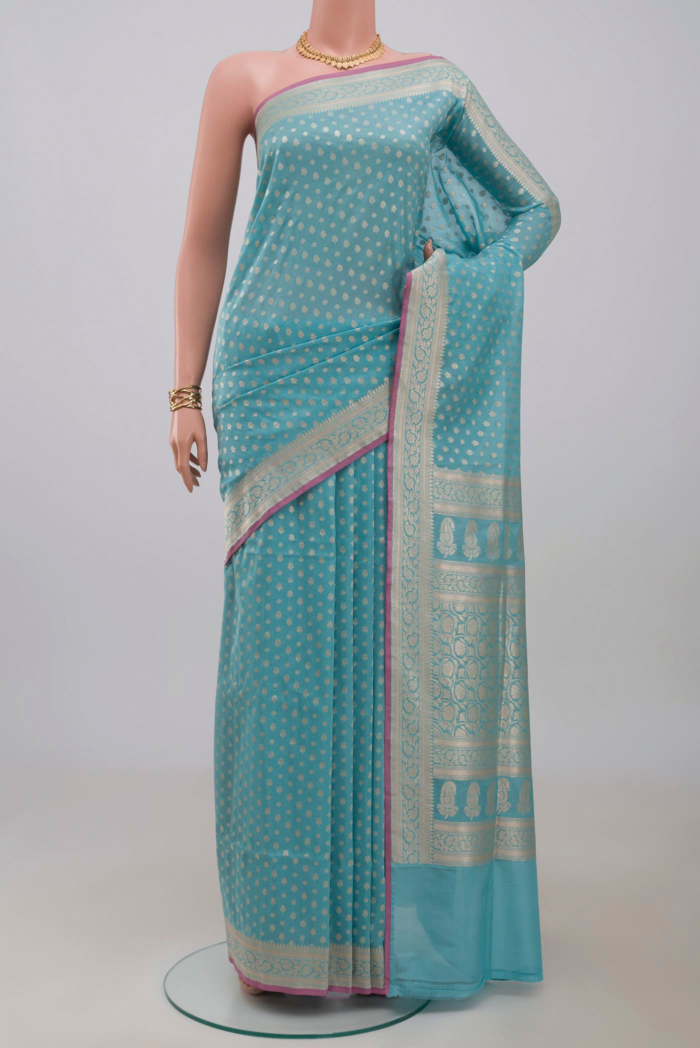 Light Blue Banarasi Silk Saree with Zari Butta on the body and Zari Border.  displayed on a mannequin