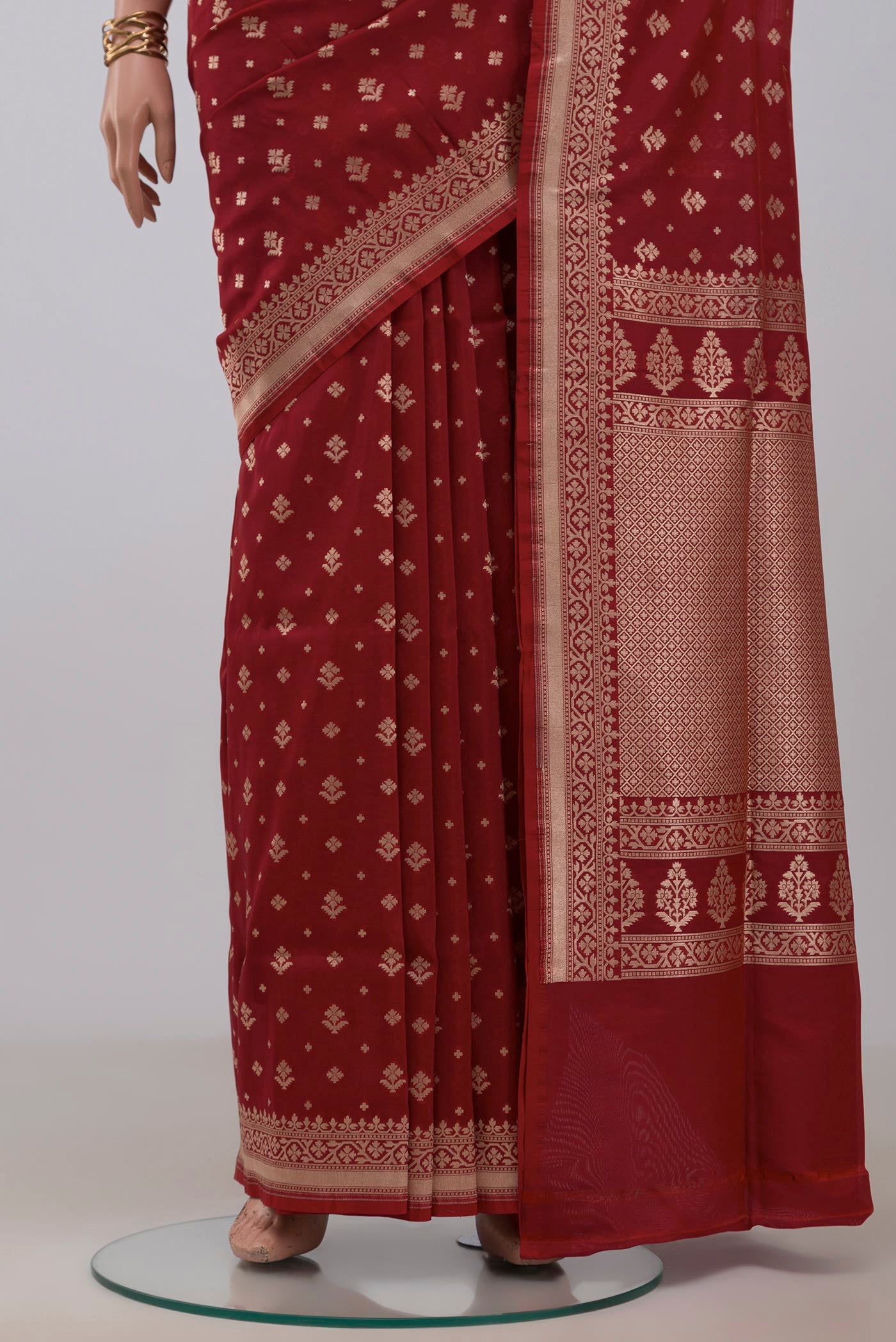 Pleats and pallu of Maroon Banarasi Saree with Zari Butta on the body and Fancy Border. 
